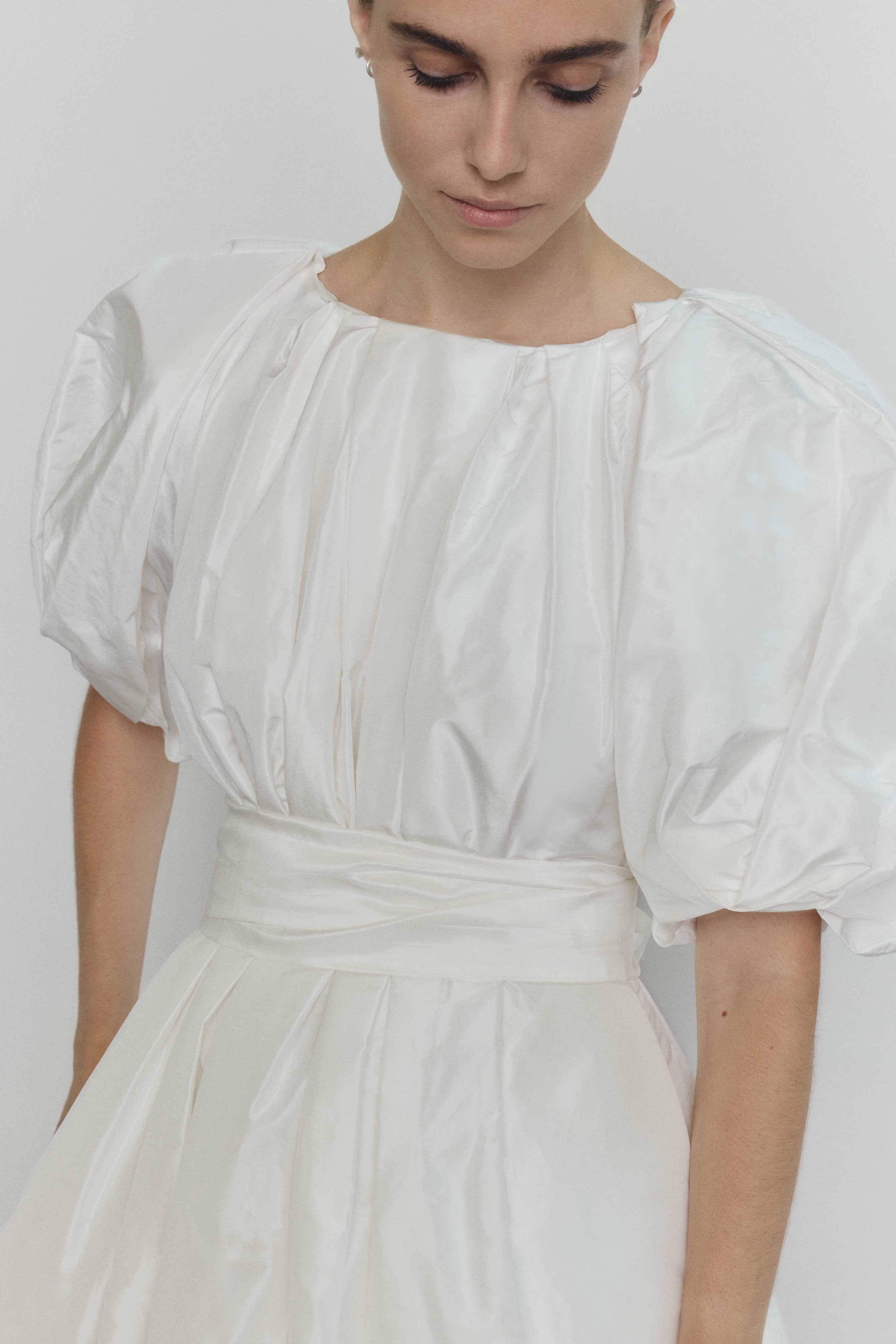 Editorial image of the white Kamperett Eva Dress showing the full bridal A-line silhouette.