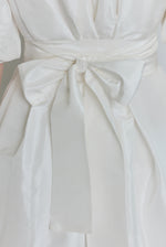 Editorial image of the white Kamperett Eva Dress styled with motion.
