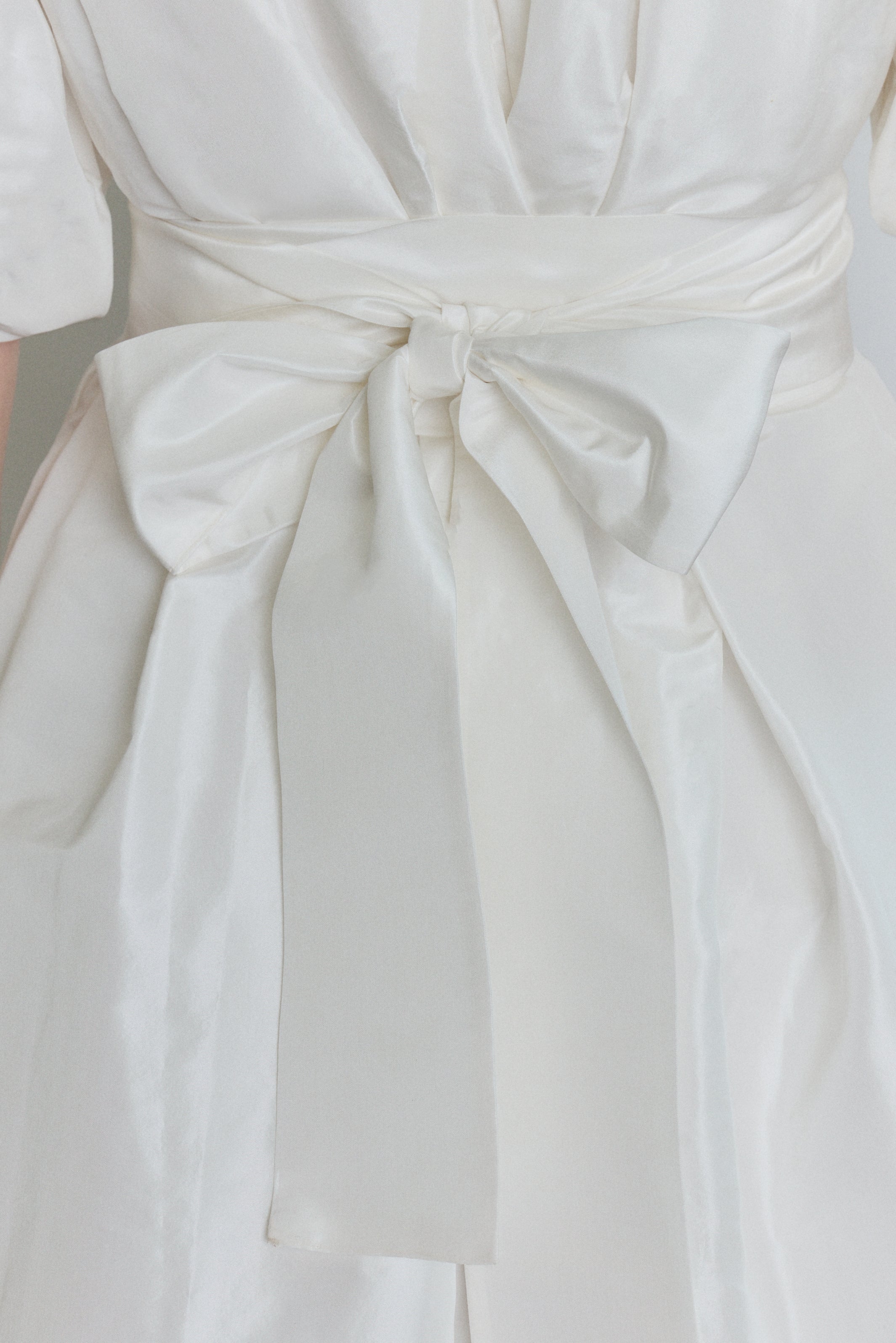 Editorial image of the white Kamperett Eva Dress styled with motion.