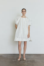 Side view of the white silk taffeta Kamperett Eva Dress showing the full A-line volume.