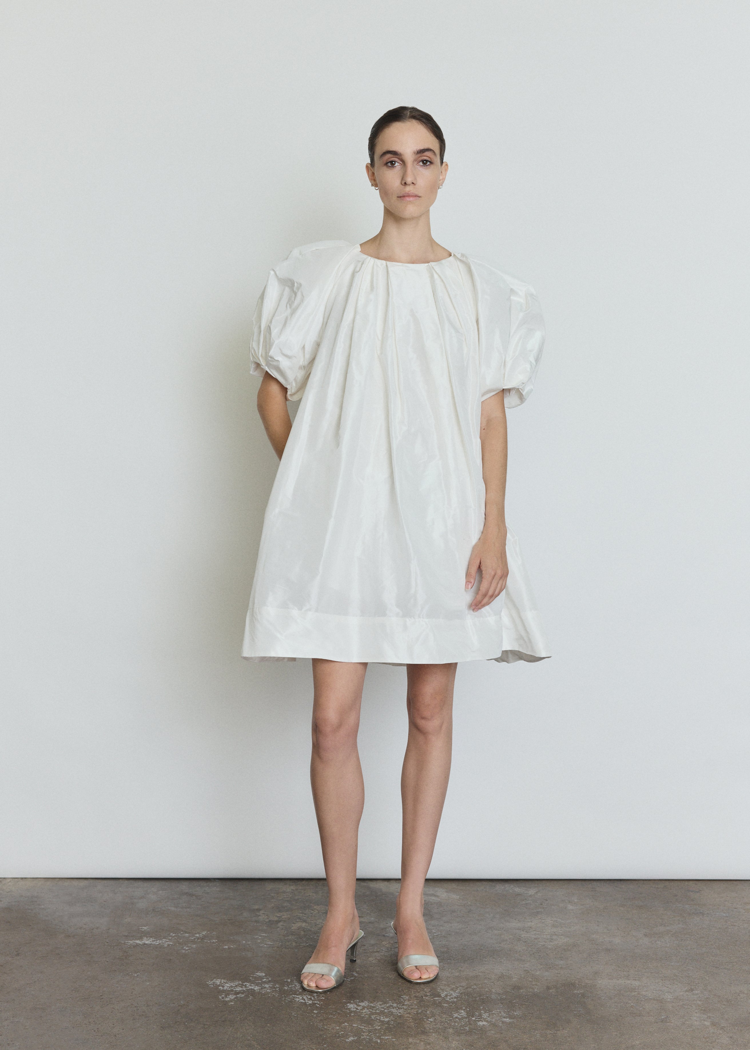 Side view of the white silk taffeta Kamperett Eva Dress showing the full A-line volume.