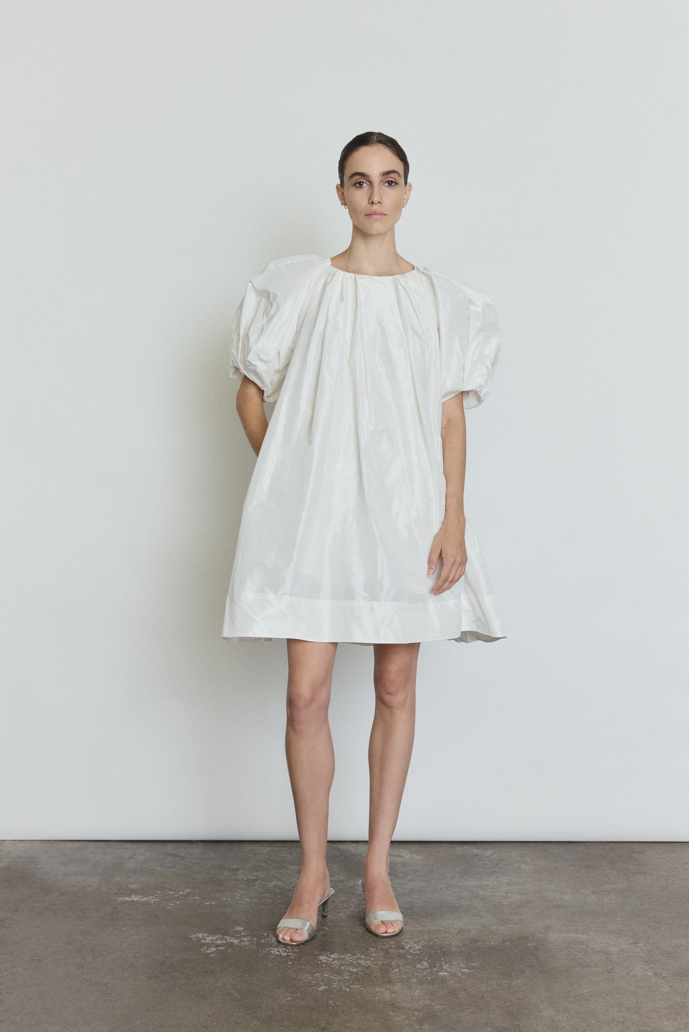 Side view of the white silk taffeta Kamperett Eva Dress showing the full A-line volume.