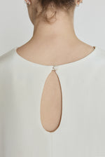 Detail of the alabaster silk crepe Kamperett Galerie Dress showing the fabric and neckline construction.