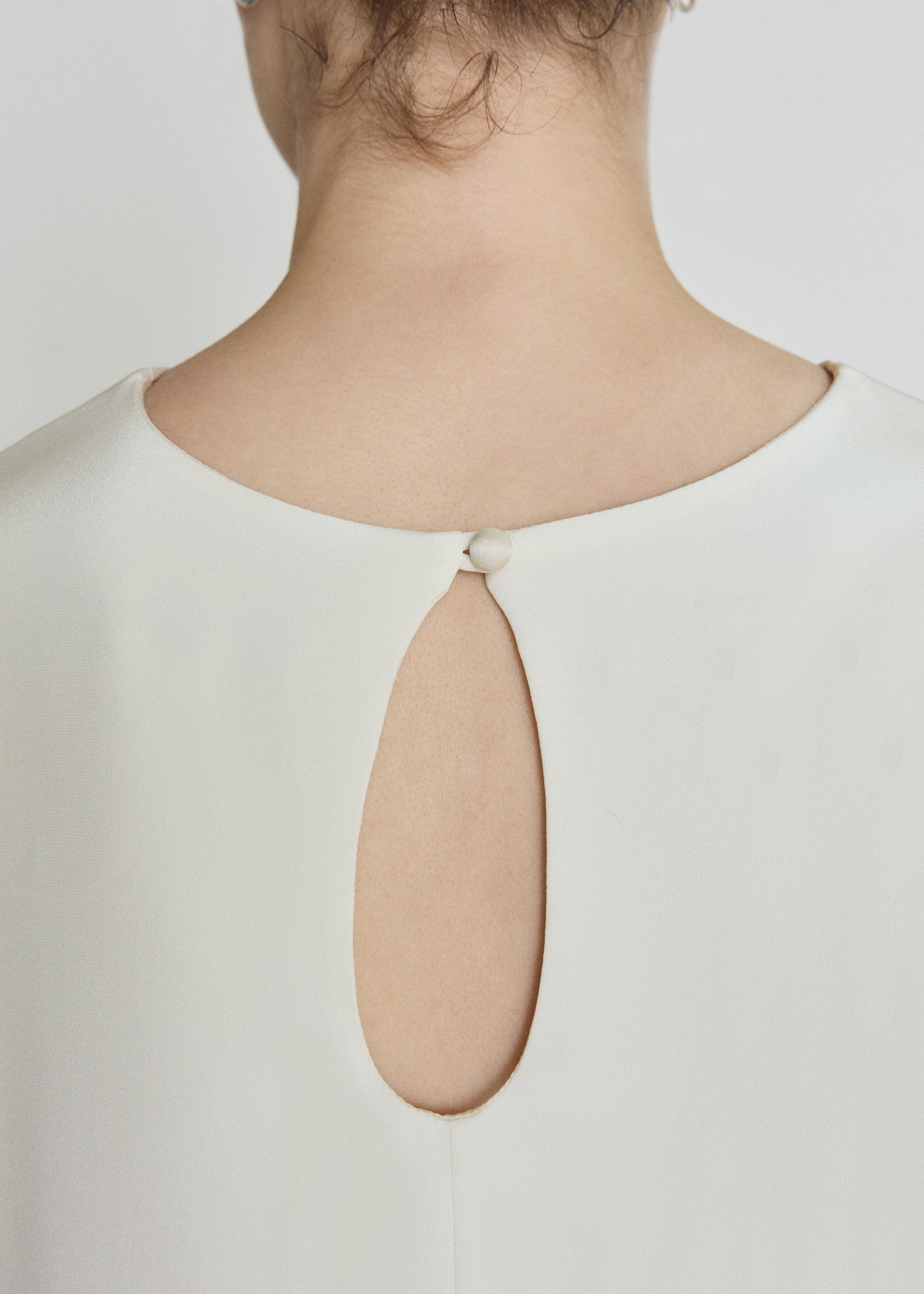 Detail of the alabaster silk crepe Kamperett Galerie Dress showing the fabric and neckline construction.
