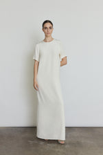Front view of a bride wearing the alabaster silk crepe Kamperett Galerie Dress, a minimalist column wedding gown with clean crew neckline.
