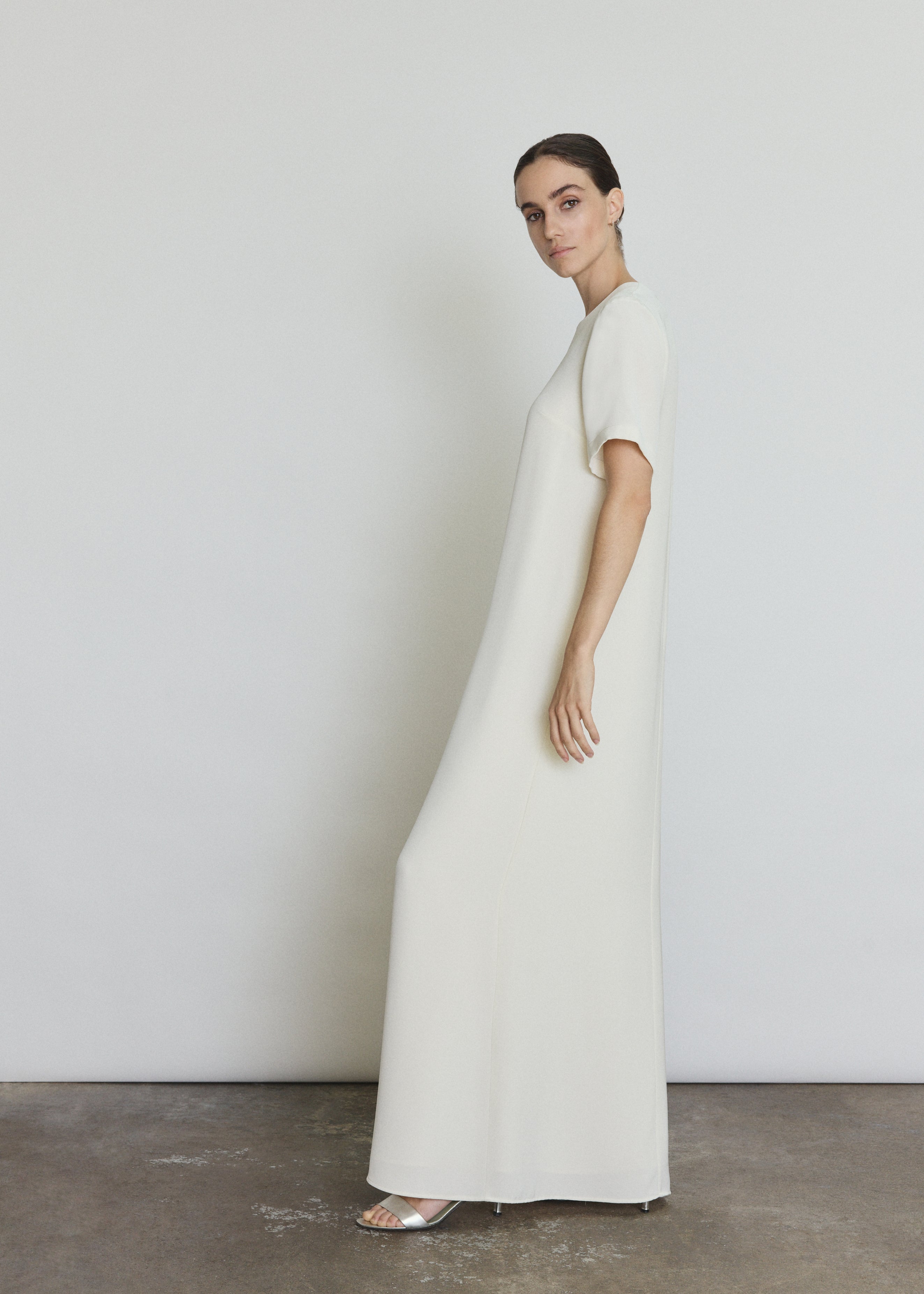 Side view of the alabaster silk crepe Kamperett Galerie Dress showing the softly defined column silhouette.