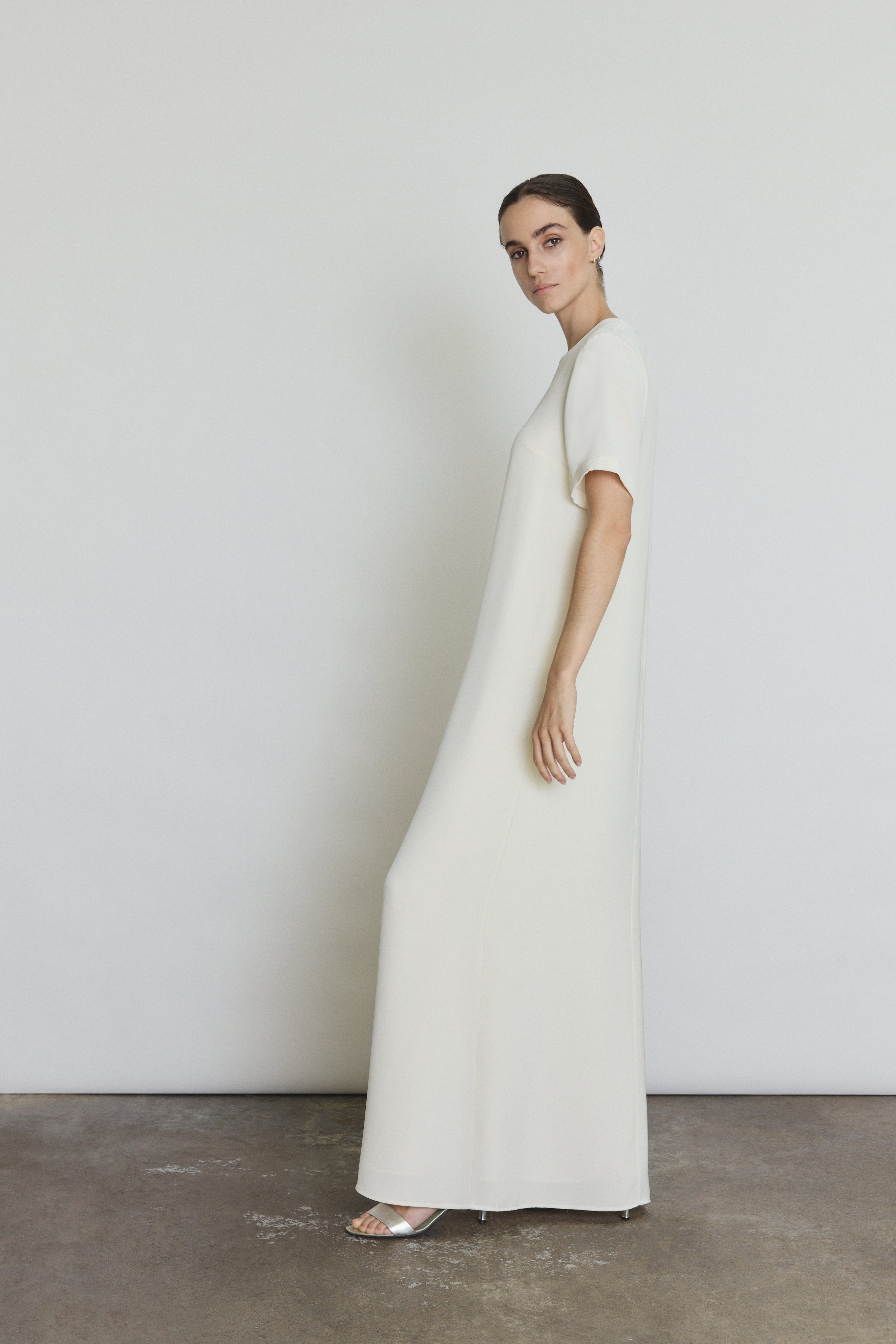 Side view of the alabaster silk crepe Kamperett Galerie Dress showing the softly defined column silhouette.