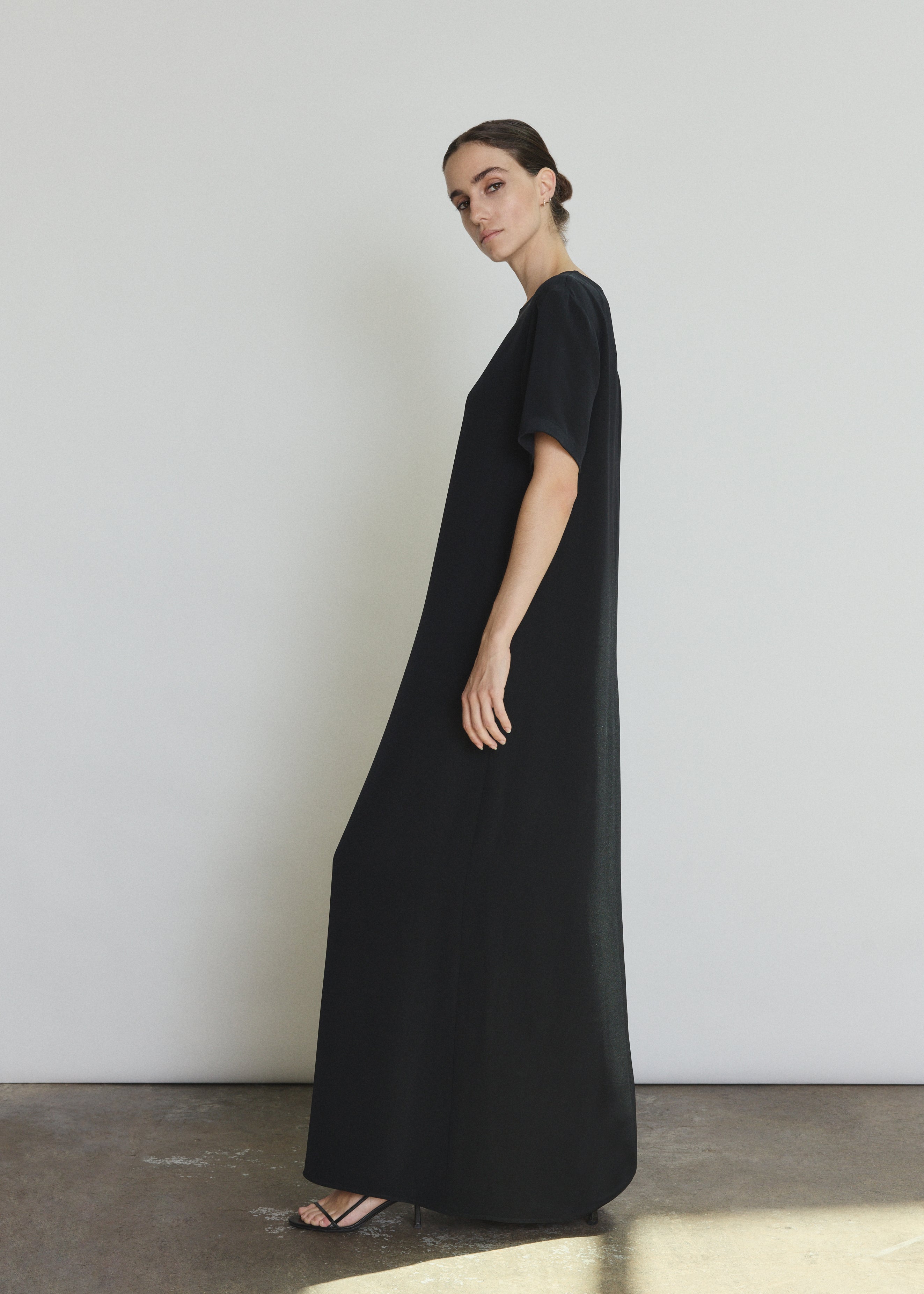 Detail of the black silk crepe Kamperett Galerie Dress showing the fabric and neckline construction.