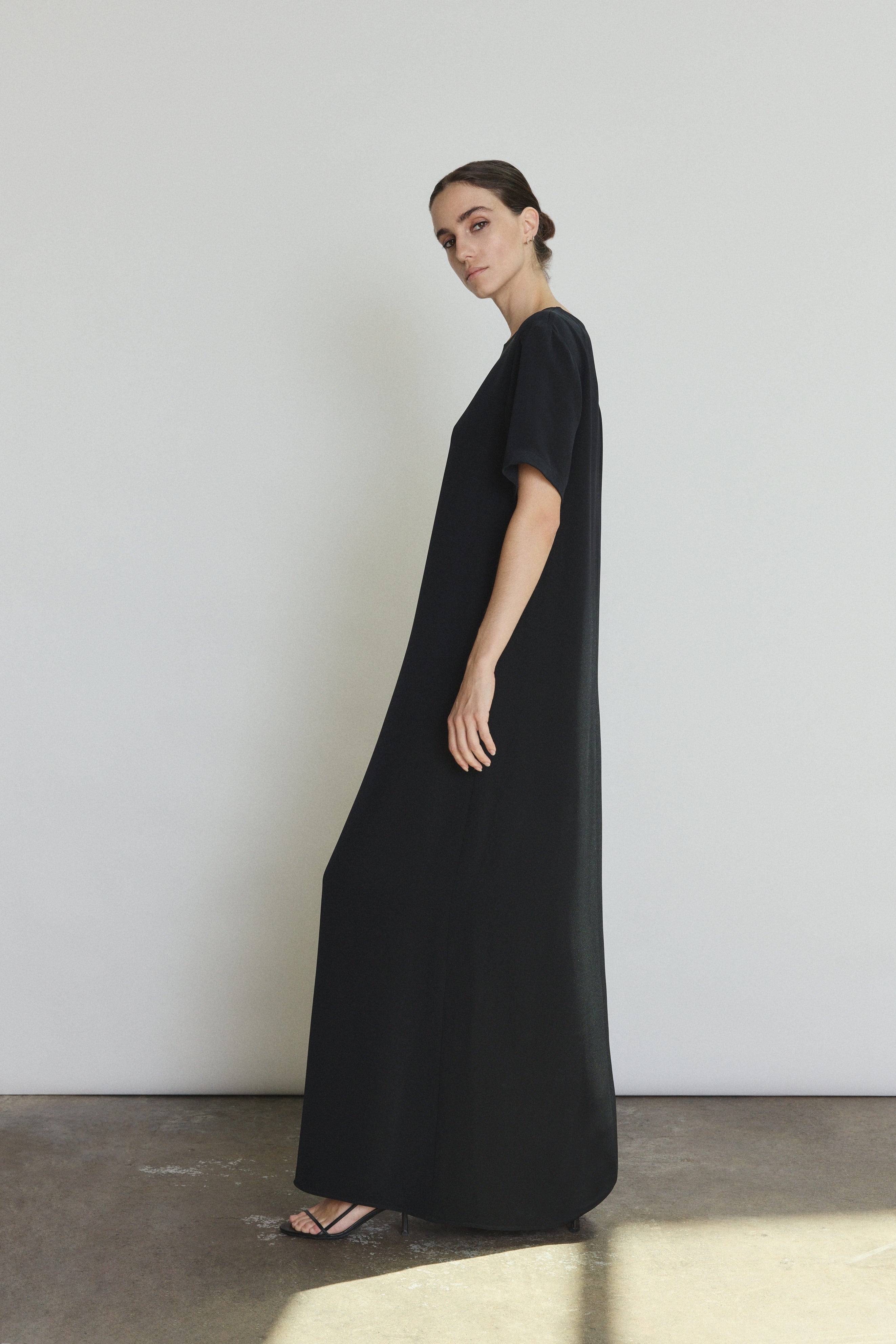 Detail of the black silk crepe Kamperett Galerie Dress showing the fabric and neckline construction.