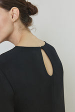 Side view of the black silk crepe Kamperett Galerie Dress showing the softly defined column silhouette.