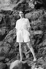 Editorial image of a model wearing the ivory Japanese linen Kamperett Henri Short.