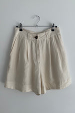 Front view of the ivory Japanese linen Kamperett Henri Short with two-pleat front and fitted waistband.