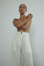 Detail of the pleated front and fitted waistband on the ivory Japanese linen Kamperett Huene Pant.