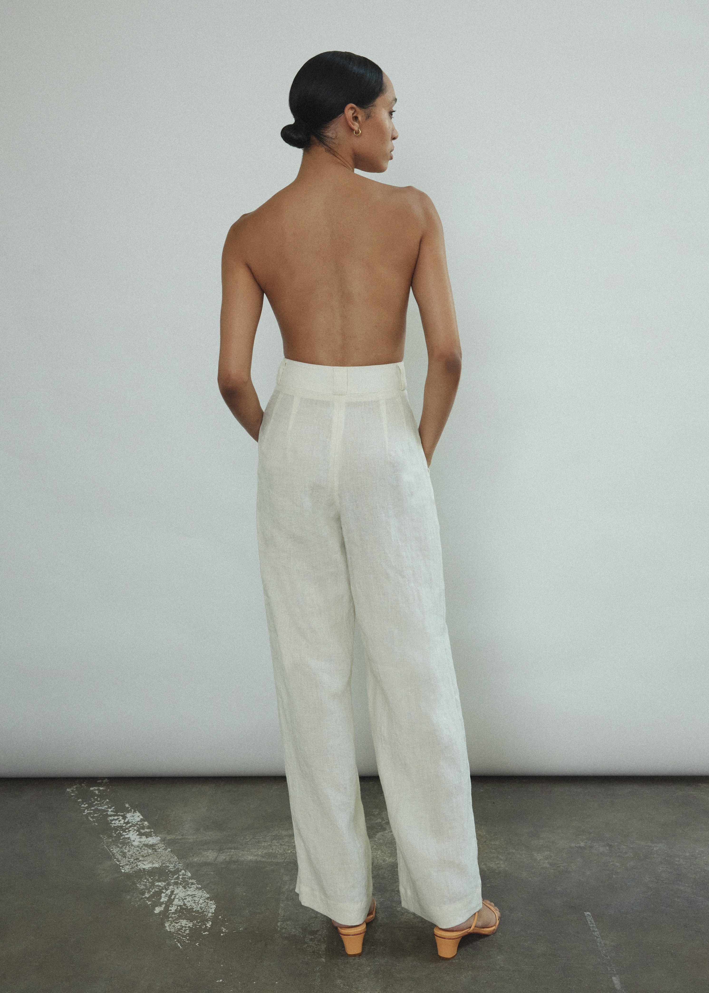 Side view of the ivory Japanese linen Kamperett Huene Pant showing the wide-leg silhouette.