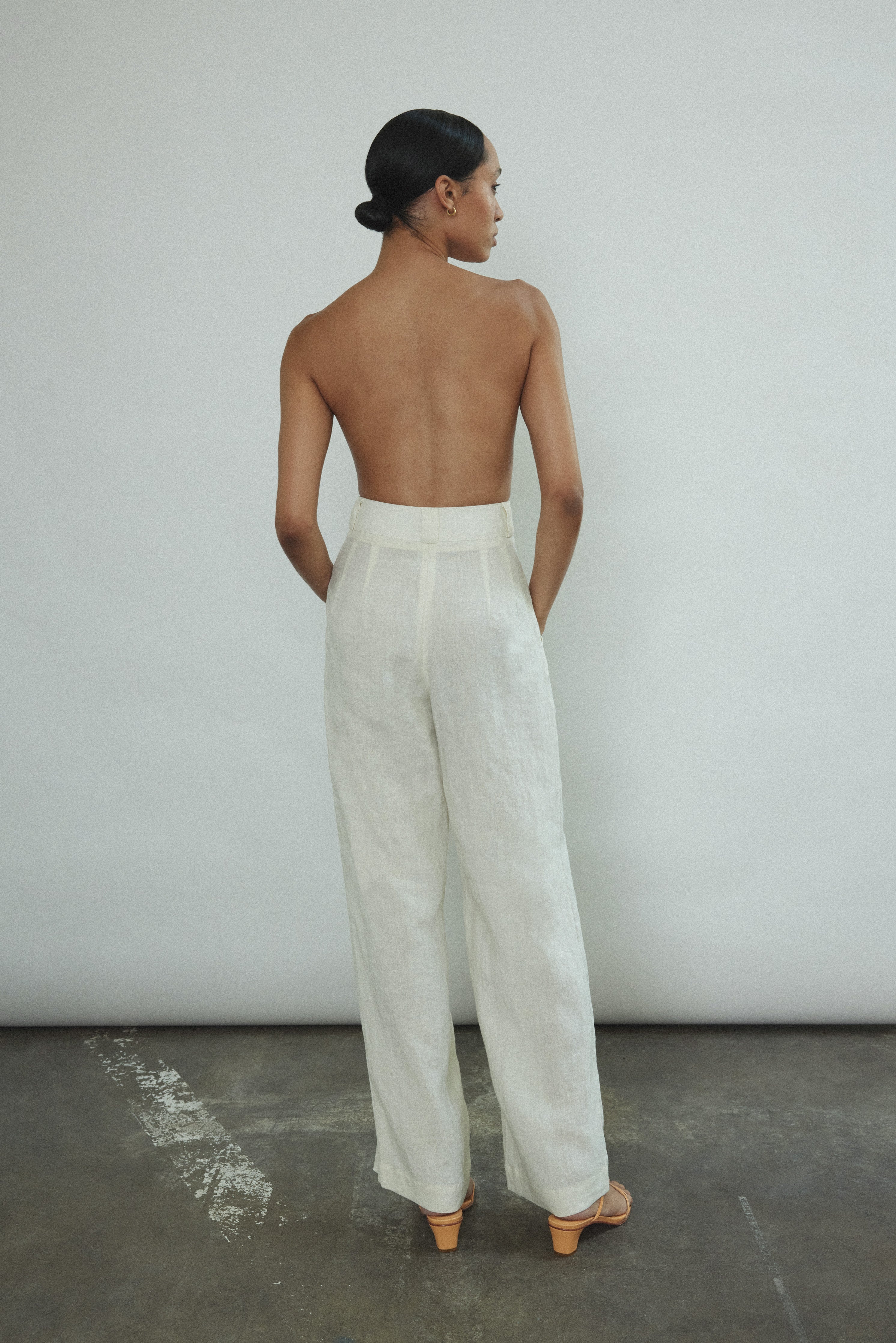 Side view of the ivory Japanese linen Kamperett Huene Pant showing the wide-leg silhouette.