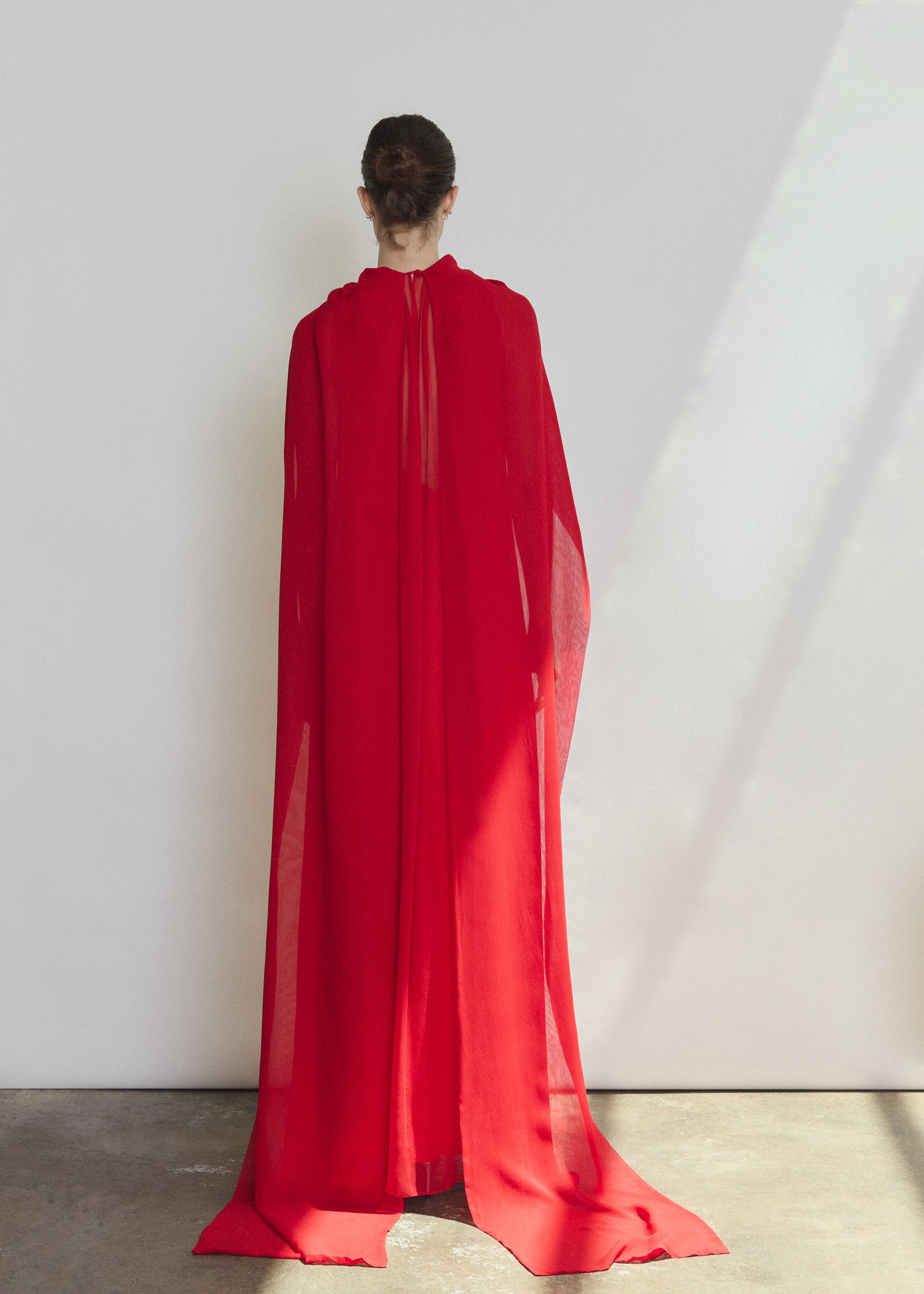 Detail of the crimson silk chiffon Kamperett Iris Gown showing the gathered neckline and drape.
