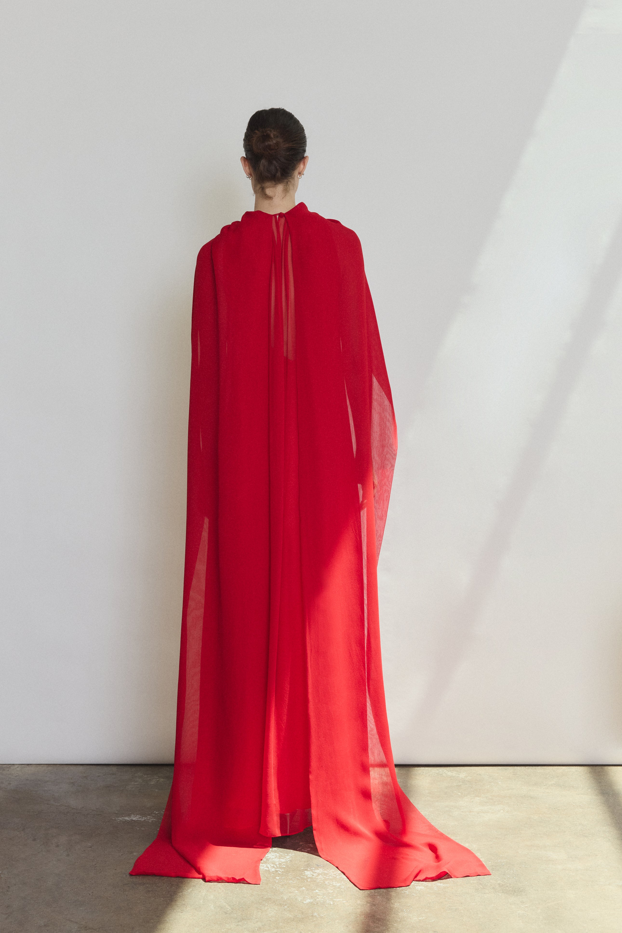 Detail of the crimson silk chiffon Kamperett Iris Gown showing the gathered neckline and drape.