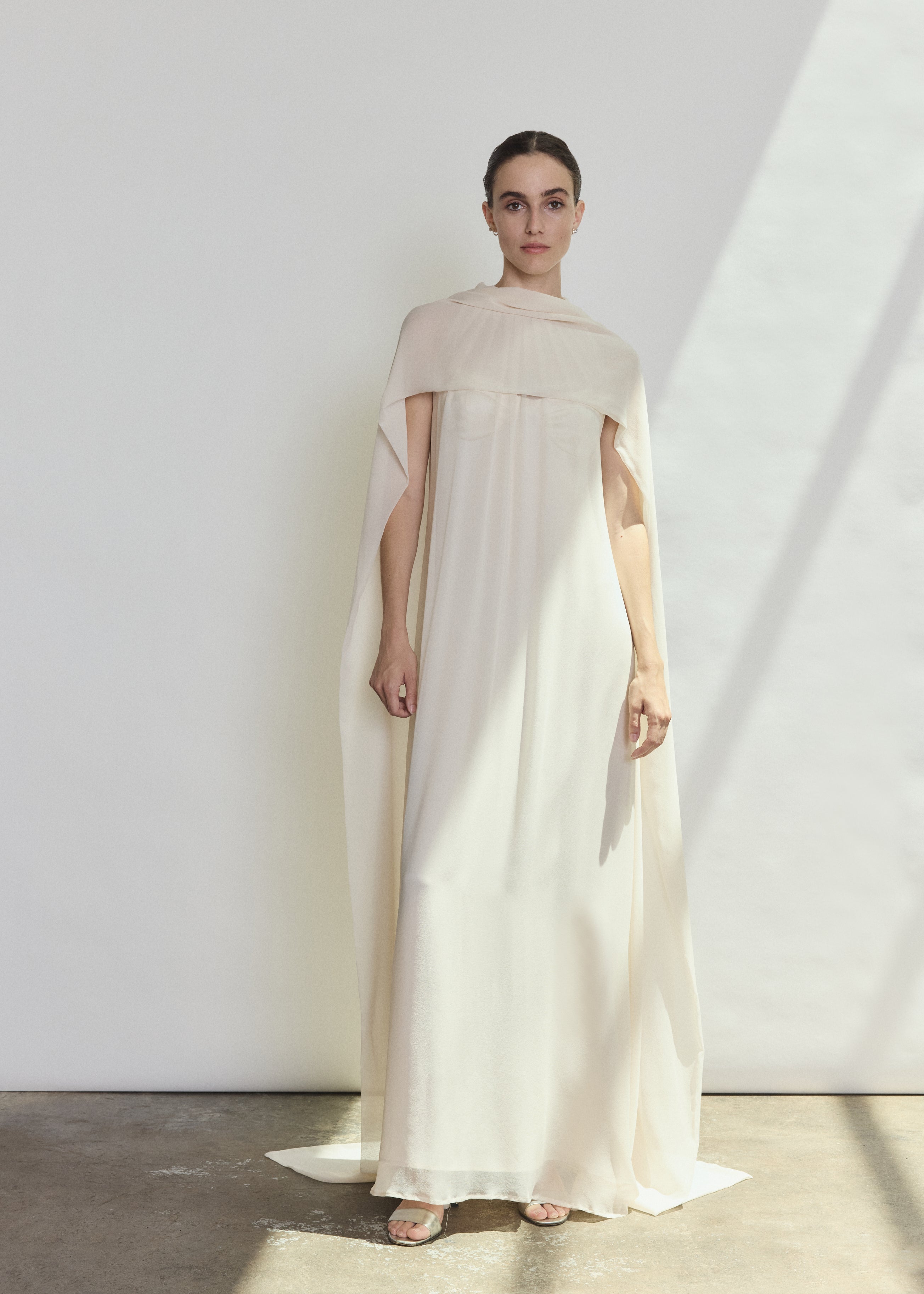 Back view of the ivory silk chiffon Kamperett Iris Gown showing the column silhouette and draped scarf neckline.