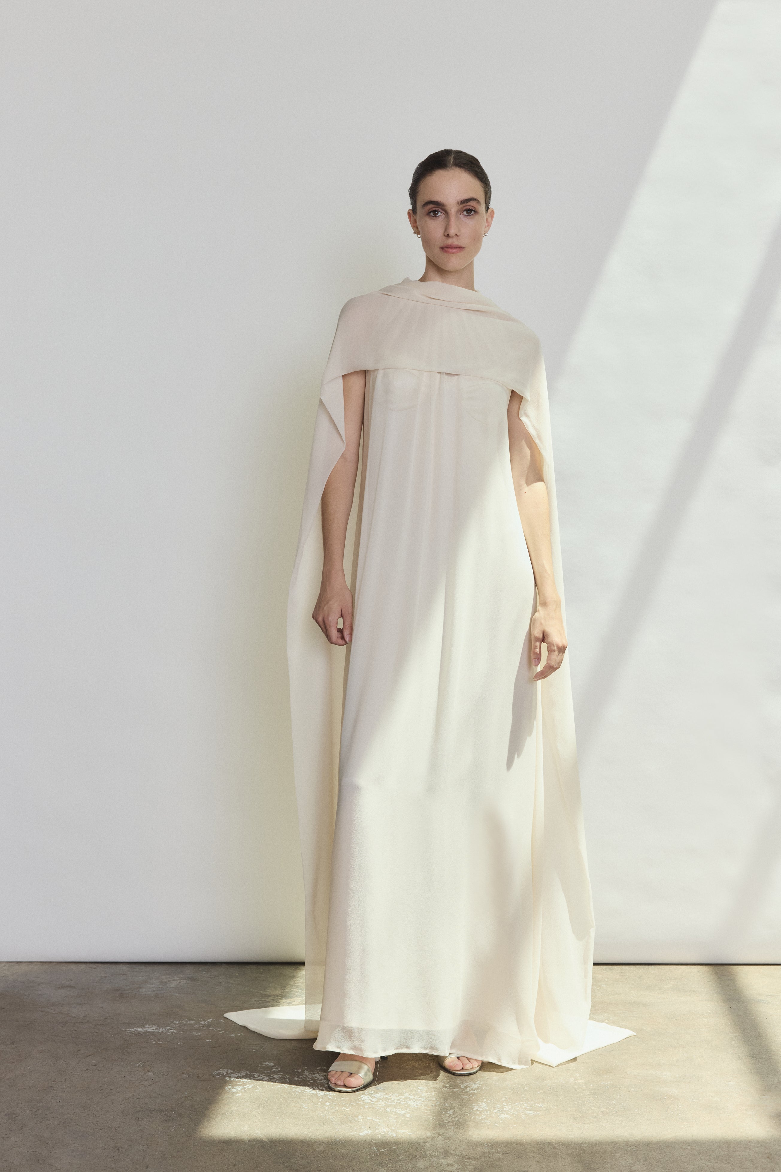 Back view of the ivory silk chiffon Kamperett Iris Gown showing the column silhouette and draped scarf neckline.