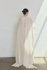 Editorial image of a bride wearing the ivory Kamperett Iris Gown layered over the Caroline Slip Dress in Ivory.