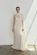 Front view of a bride wearing the ivory silk chiffon Kamperett Iris Gown, a scarf-neck column wedding gown with integrated capelet.