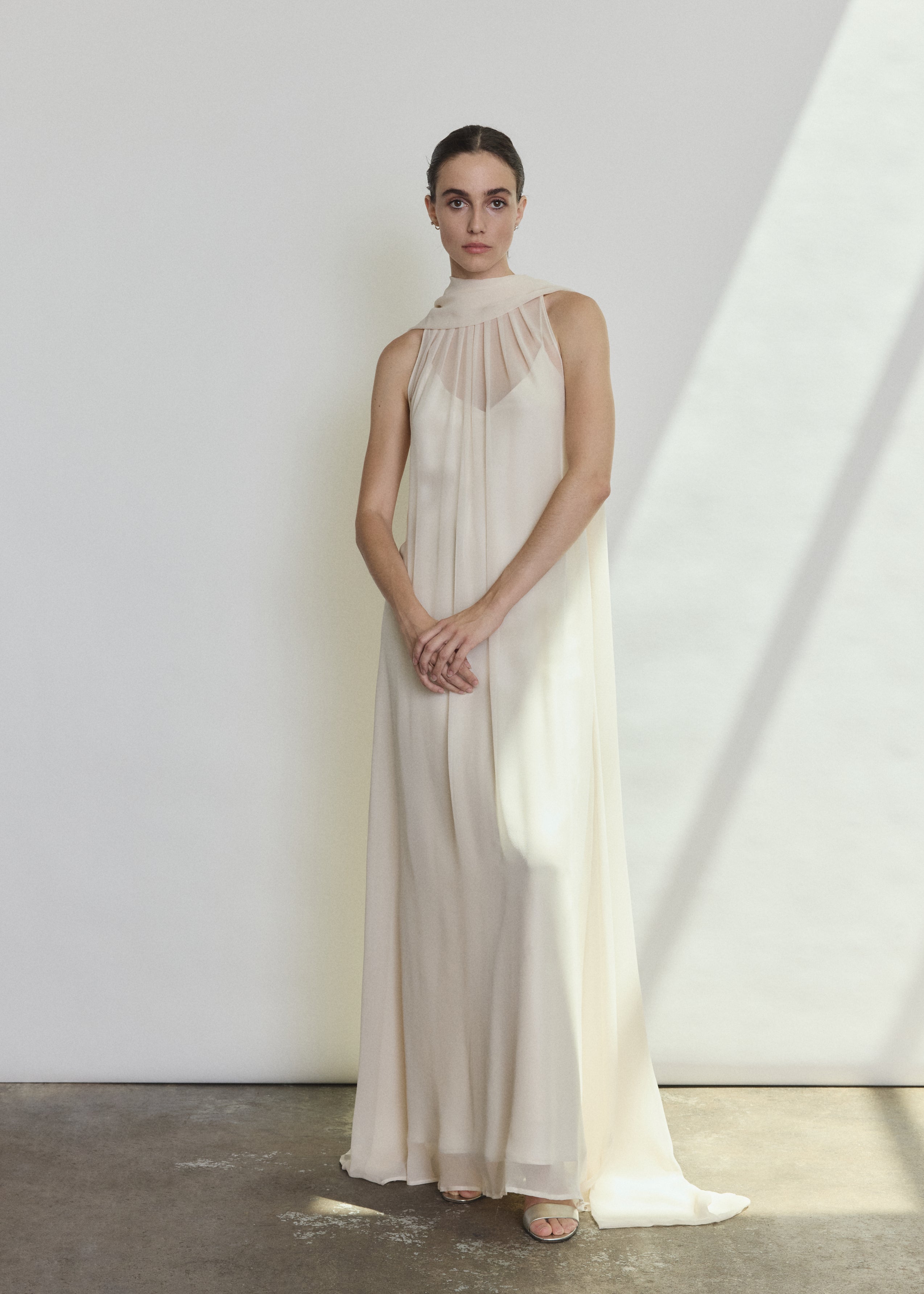 Side view of the ivory silk chiffon Kamperett Iris Gown showing the floating capelet.