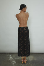 Back view of the black French lace Kamperett Isabella Skirt with fabric-covered button side closure.
