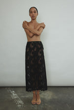 Front view of the black French lace Kamperett Isabella Skirt with contrast waist binding.