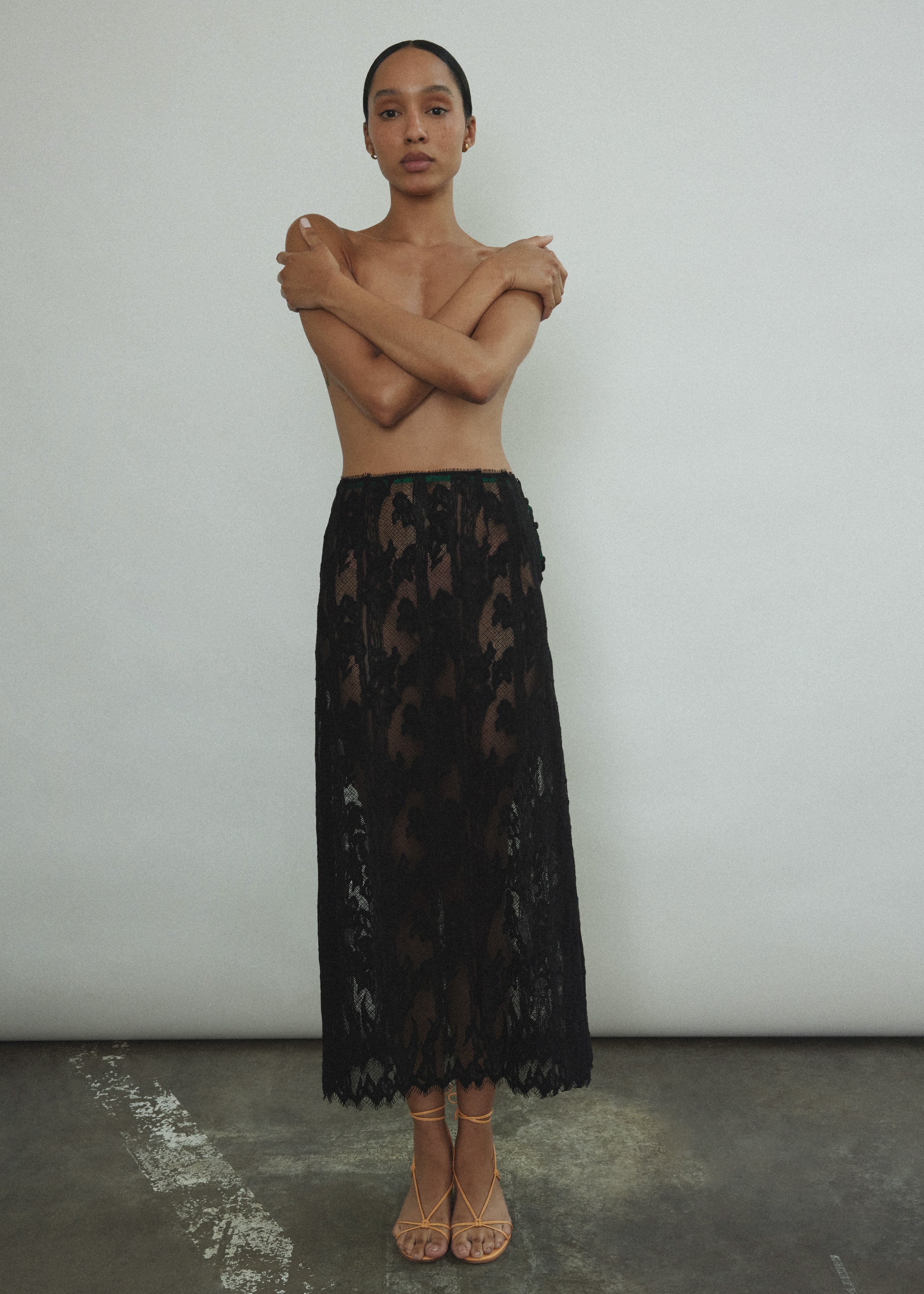 Front view of the black French lace Kamperett Isabella Skirt with contrast waist binding.