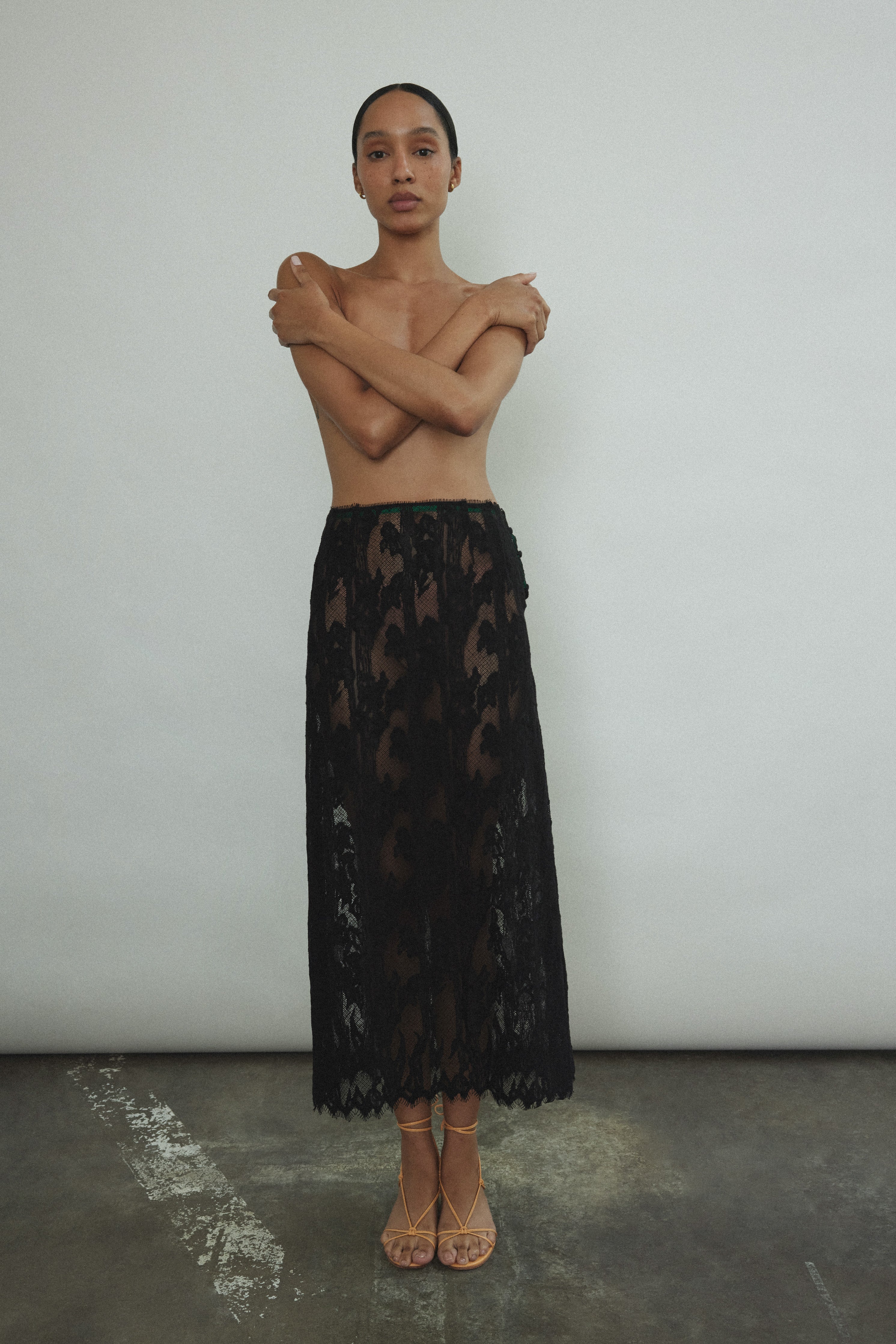 Front view of the black French lace Kamperett Isabella Skirt with contrast waist binding.