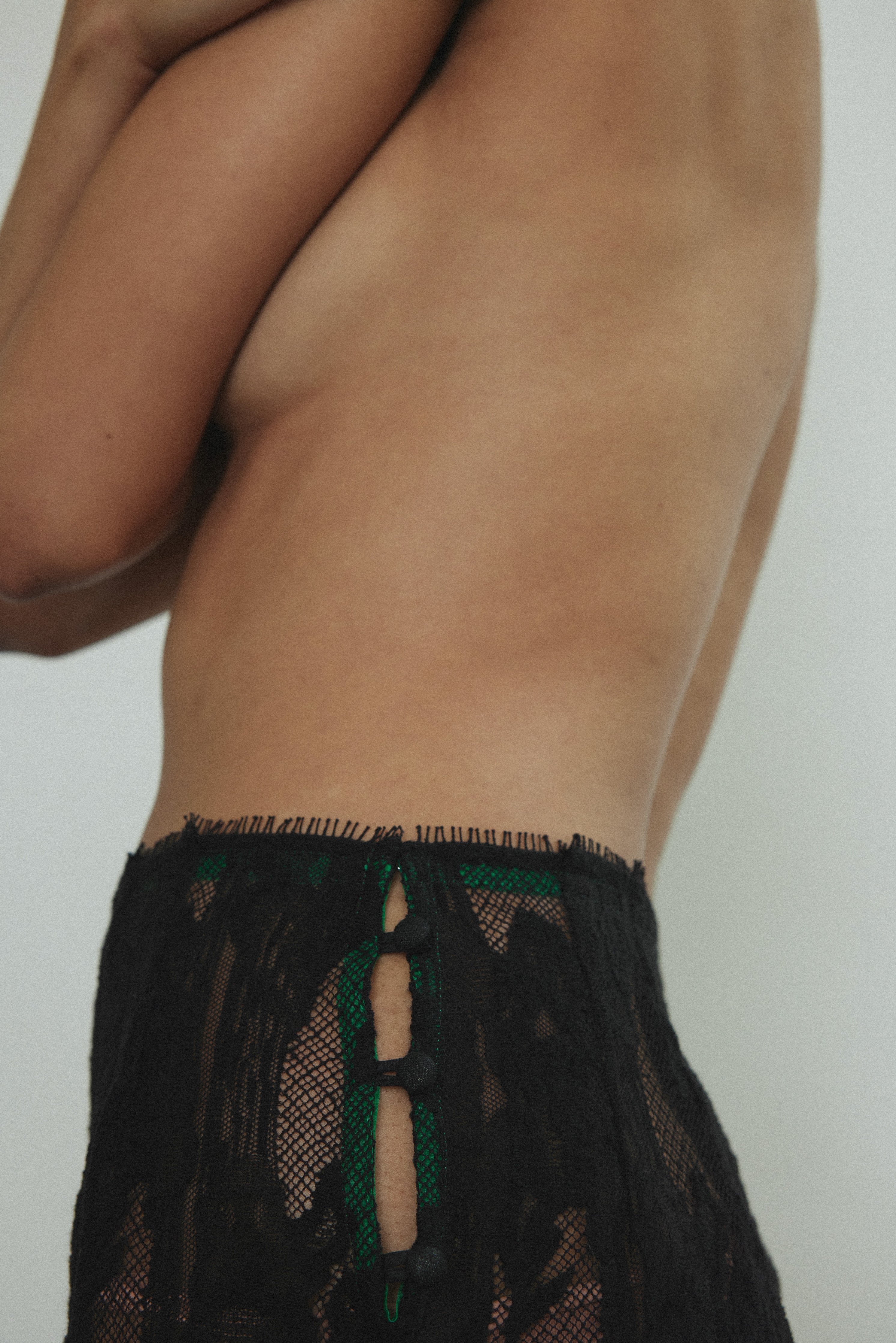 Motion shot of the black French lace Kamperett Isabella Skirt showing the fluid movement of the eyelash lace hem.