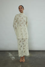 Back view of the cream French lace Kamperett Isabella Skirt with fabric-covered button side closure.