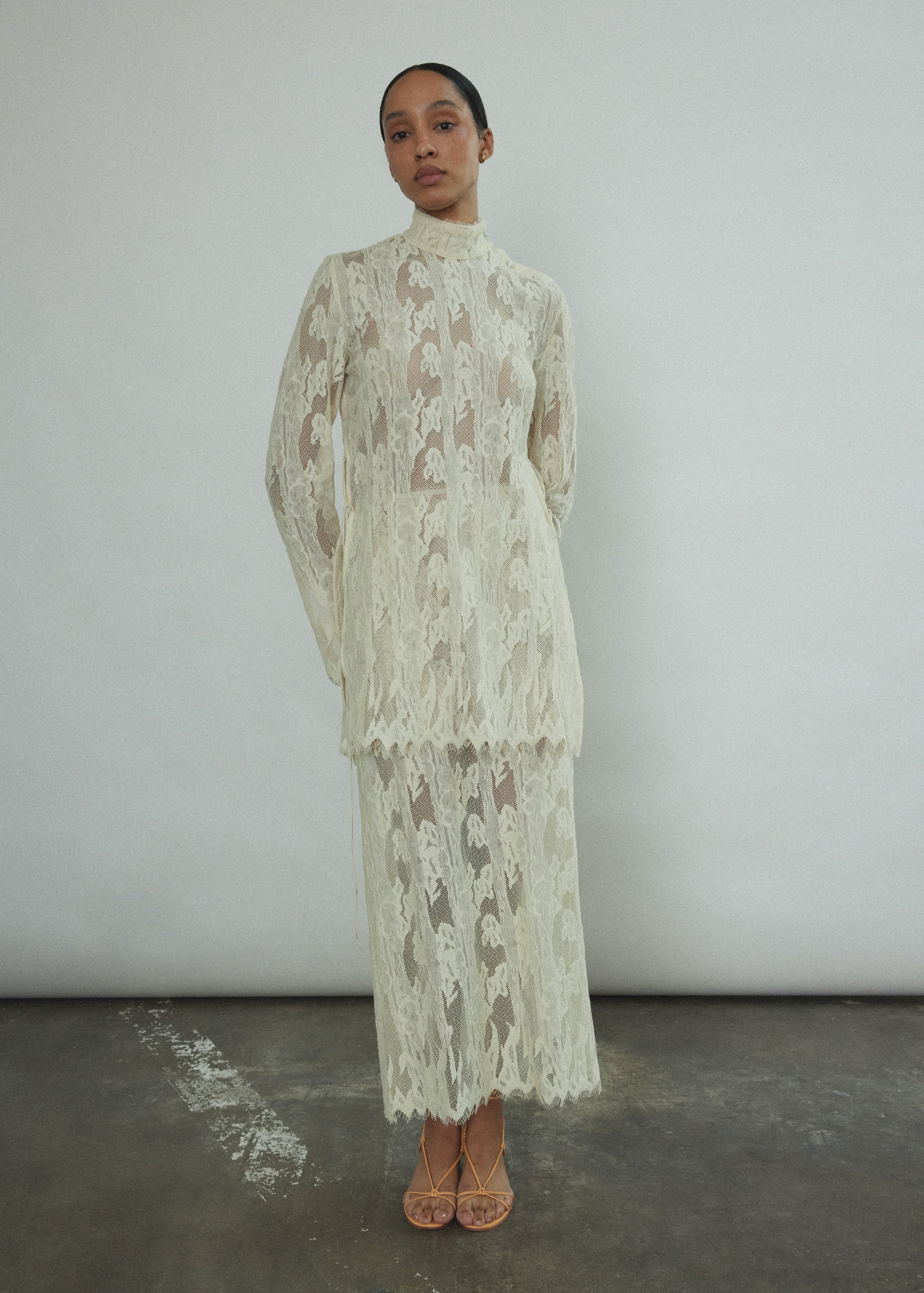 Back view of the cream French lace Kamperett Isabella Skirt with fabric-covered button side closure.