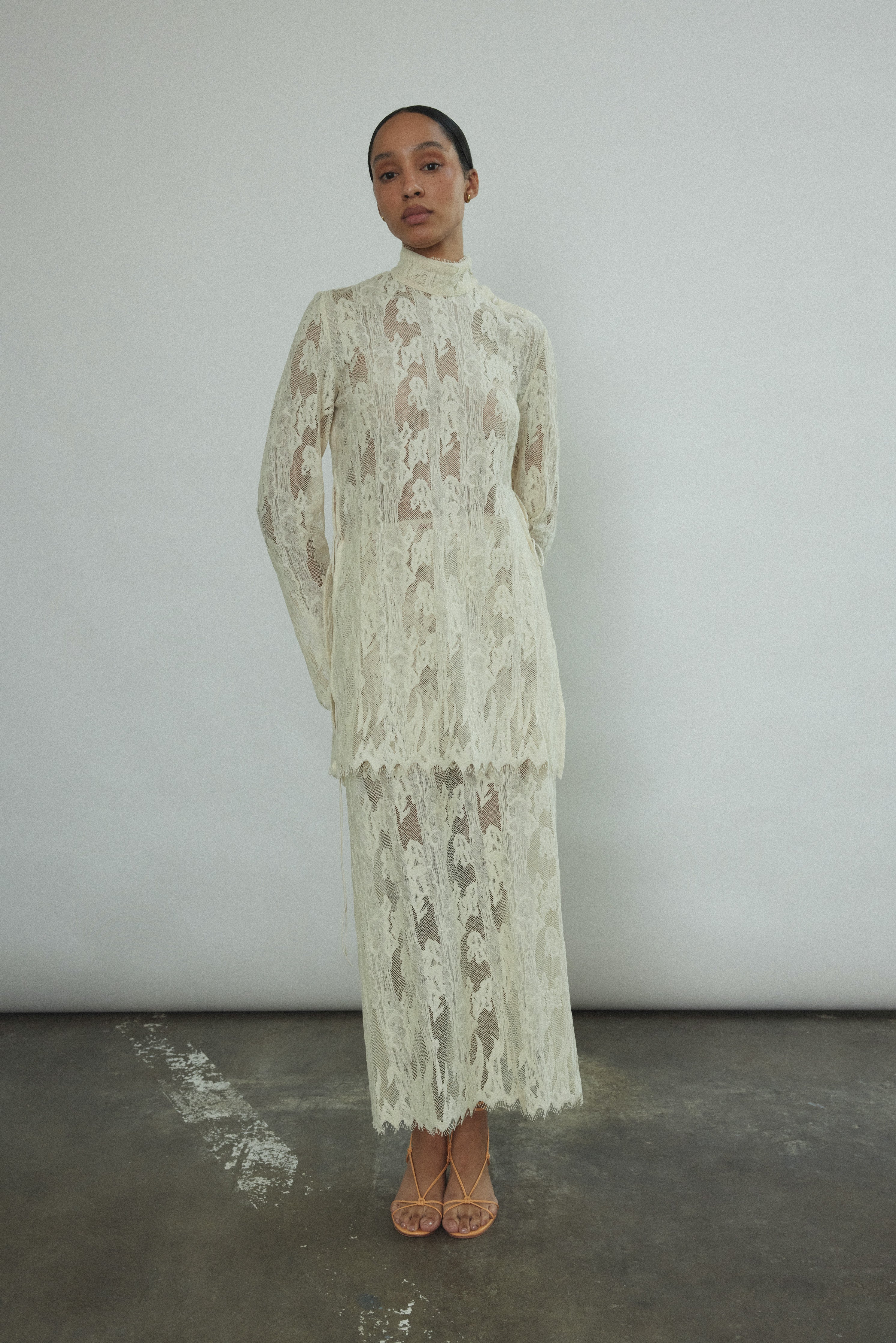 Back view of the cream French lace Kamperett Isabella Skirt with fabric-covered button side closure.