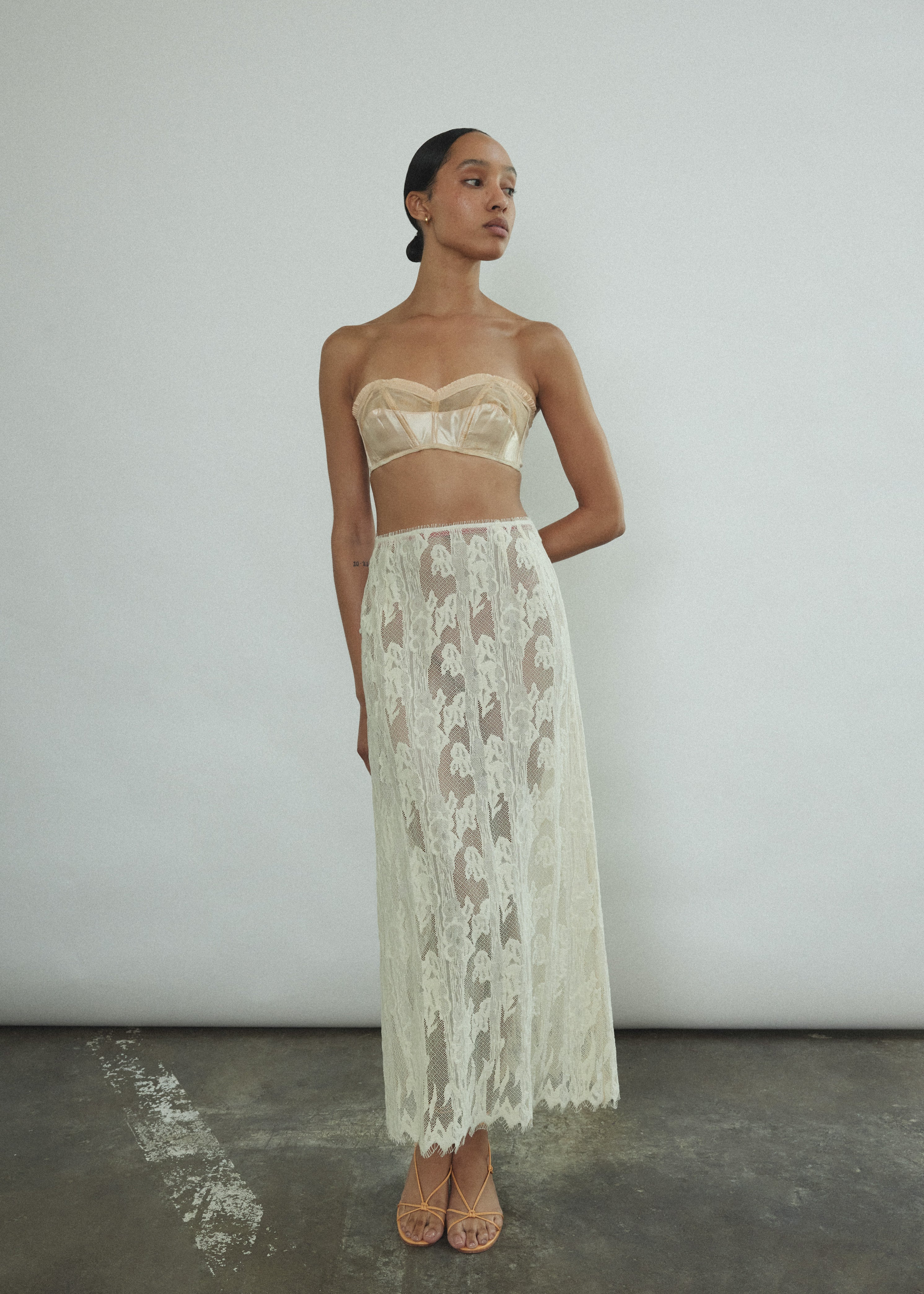Front view of a model wearing the cream French lace Kamperett Isabella Skirt with eyelash lace hem, paired with the Isabella Tunic.