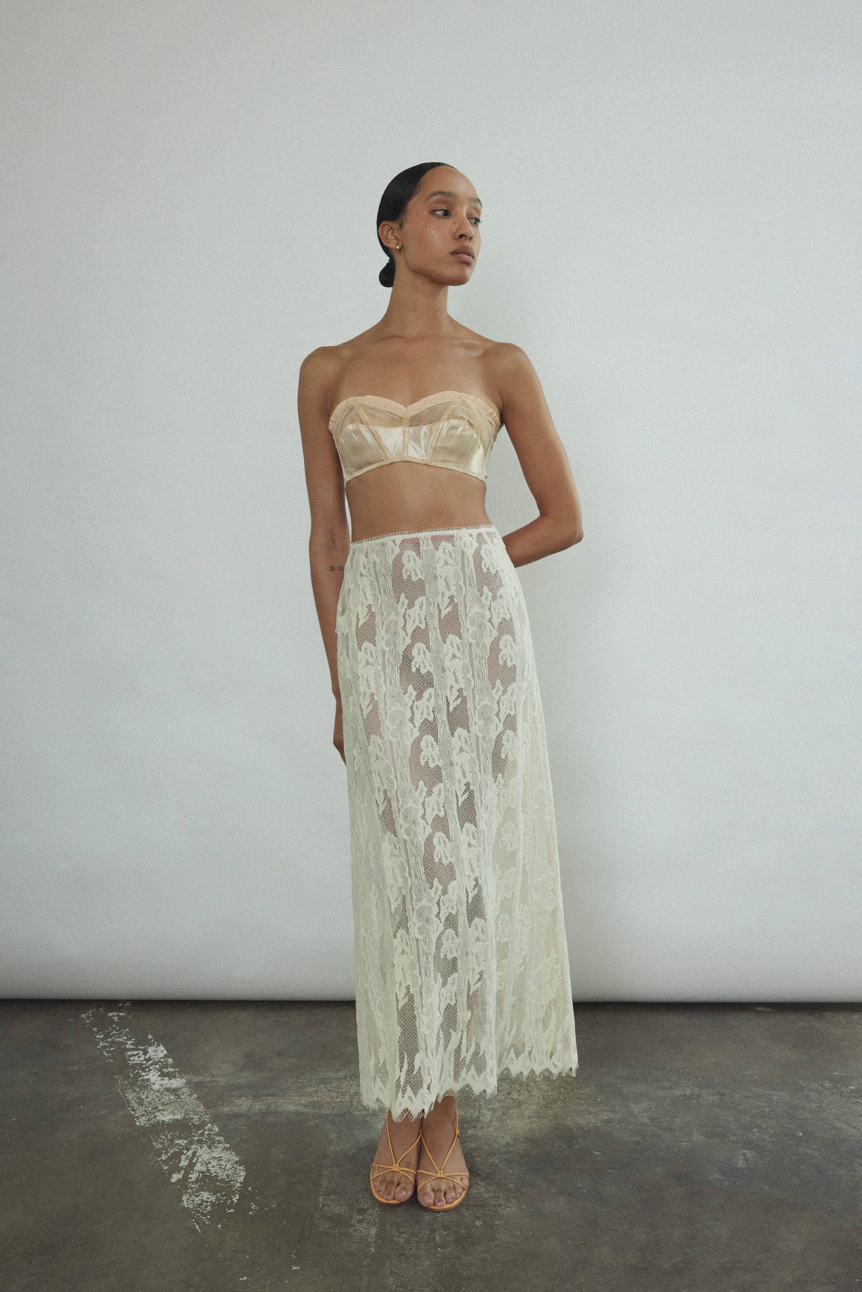 Front view of a model wearing the cream French lace Kamperett Isabella Skirt with eyelash lace hem, paired with the Isabella Tunic.