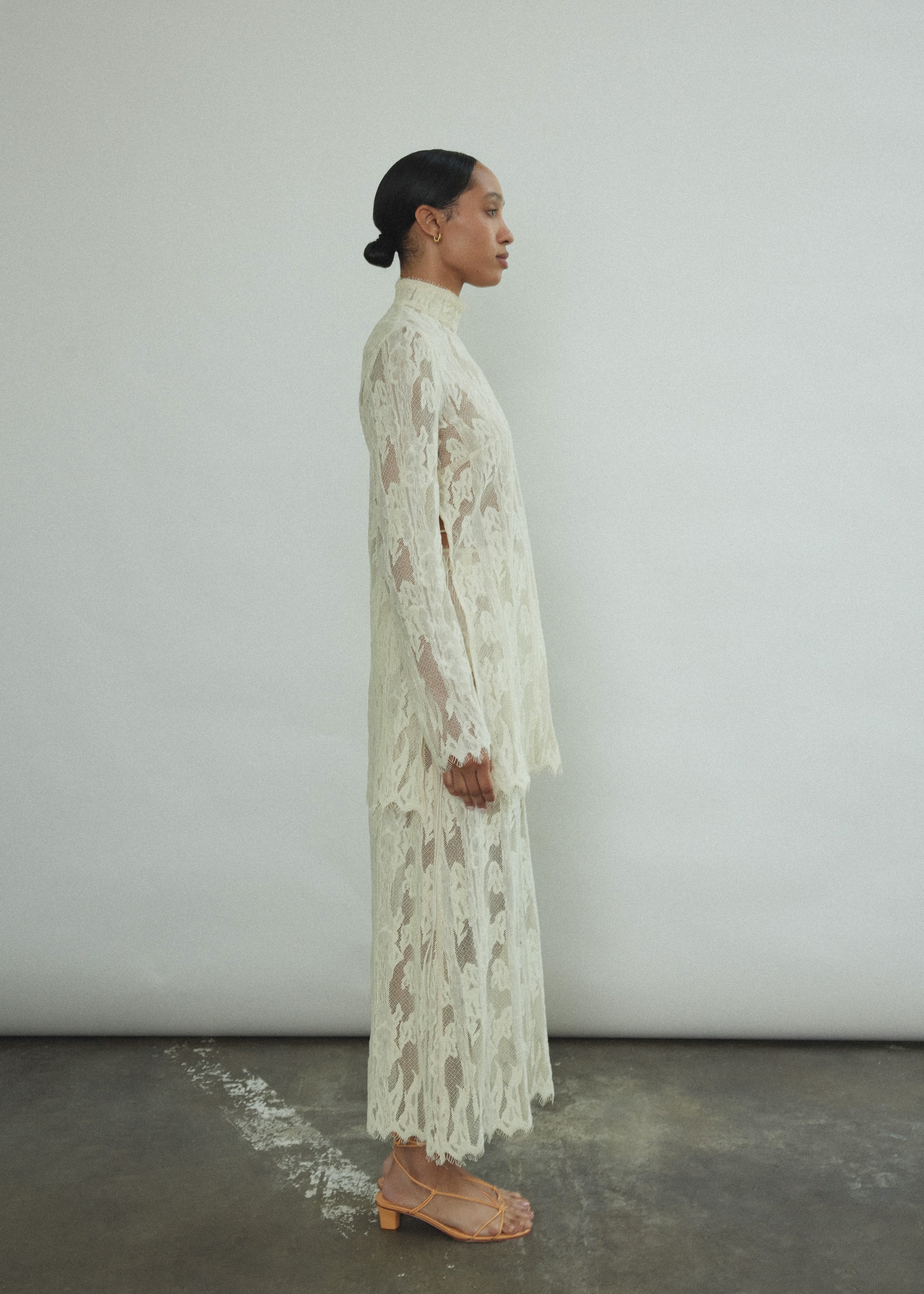 Detail of the eyelash French lace hem and contrast waist binding on the Kamperett Isabella Skirt in cream.