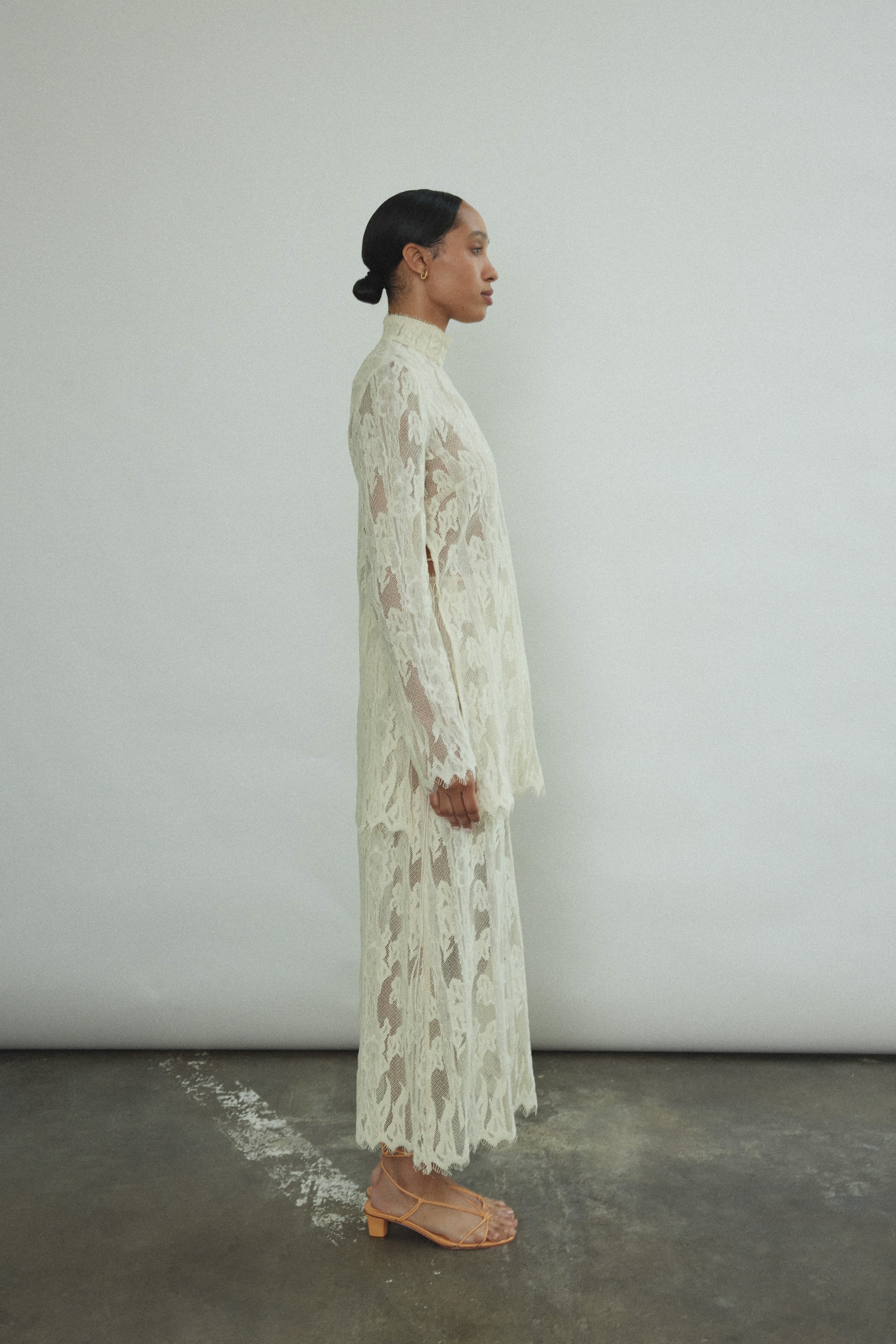 Detail of the eyelash French lace hem and contrast waist binding on the Kamperett Isabella Skirt in cream.