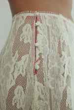 Motion shot of the cream French lace Kamperett Isabella Skirt showing the fluid movement of the eyelash lace hem.