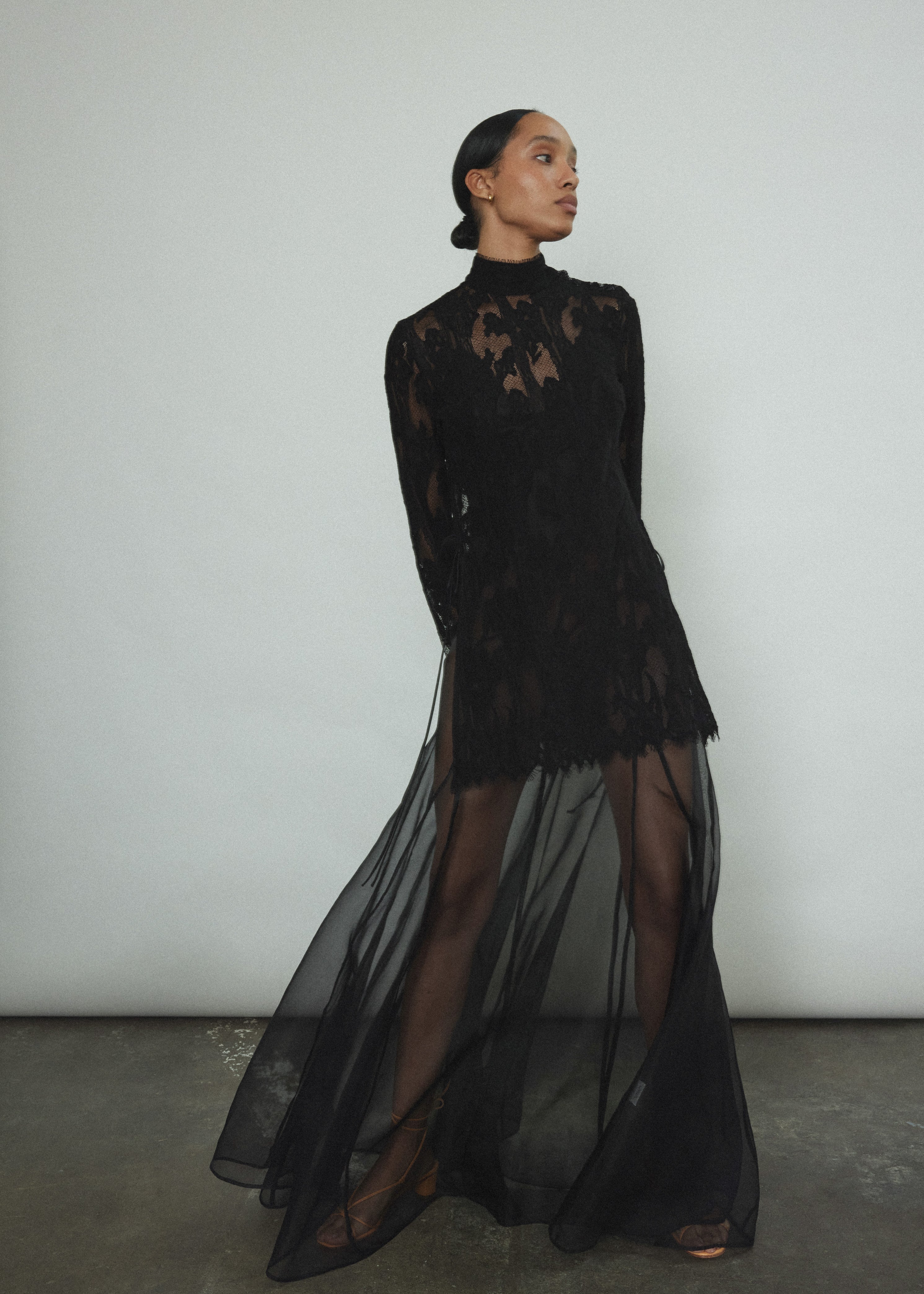 Kamperett Isabella Tunic in black French lace, front view, mock neck silhouette with eyelash lace hem and open side seams