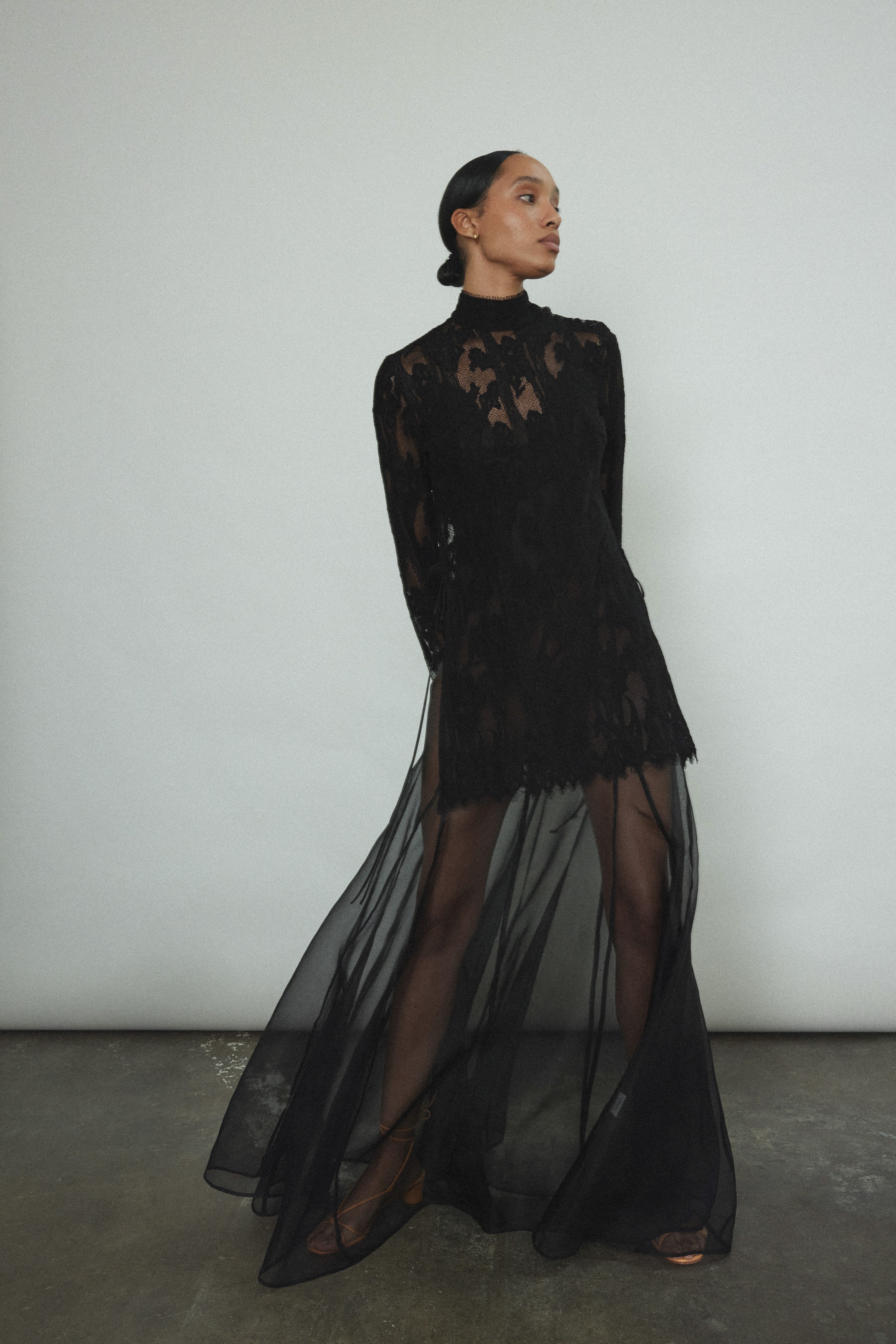 Kamperett Isabella Tunic in black French lace, front view, mock neck silhouette with eyelash lace hem and open side seams