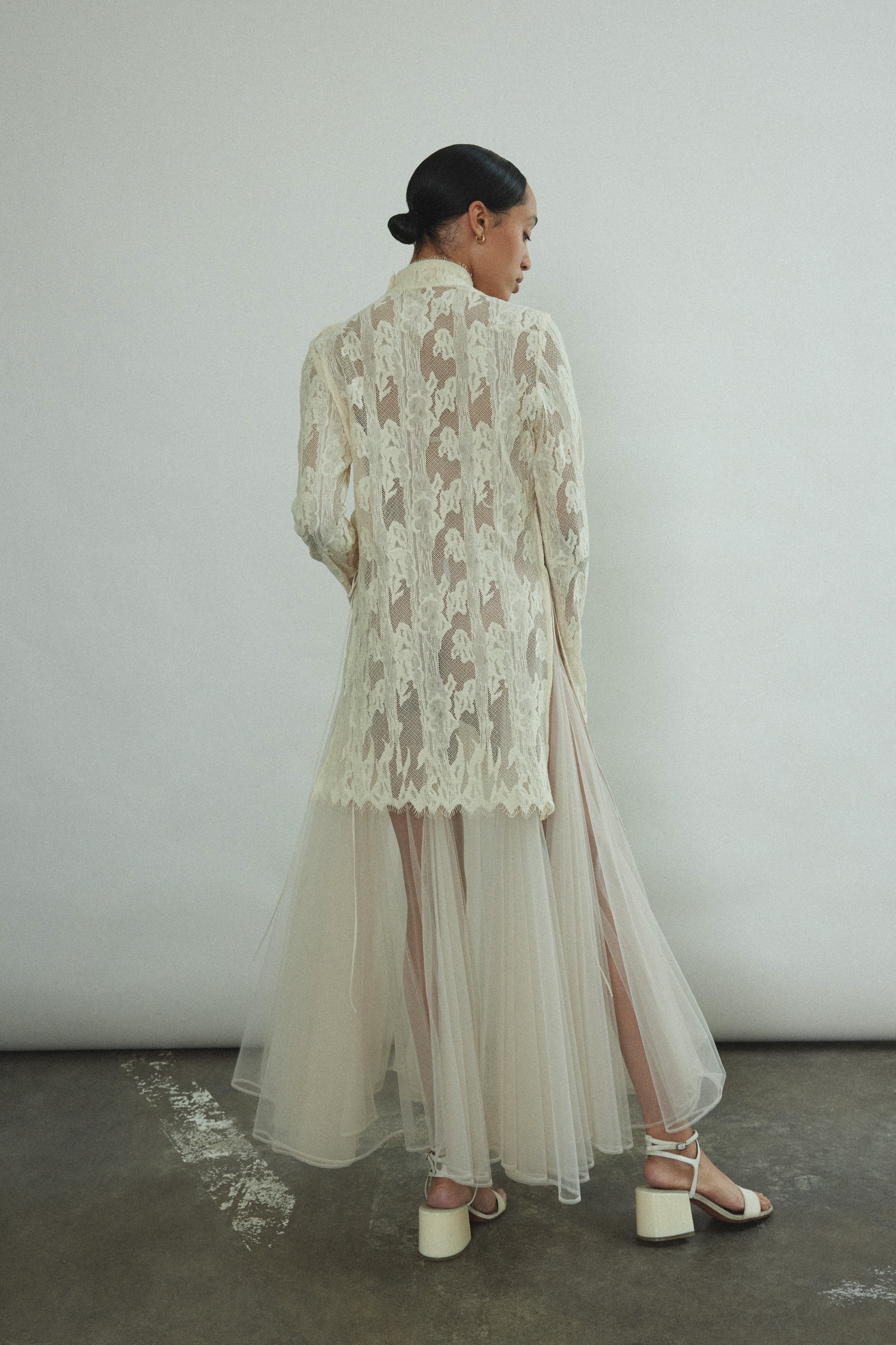 Kamperett Isabella Tunic rear view highlighting open side seams with draped silk cord ties, eyelash lace sleeve edge, and clean back construction of imported French lace.