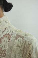 Kamperett Isabella Tunic in cream French lace, editorial close-up of structured mock neck and button closure at shoulder seam.