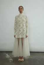 Kamperett Isabella Tunic in cream French lace, full-length front view showing straight-cut silhouette, mock neck, eyelash lace hem, and long sleeves with wrist zipper closure.