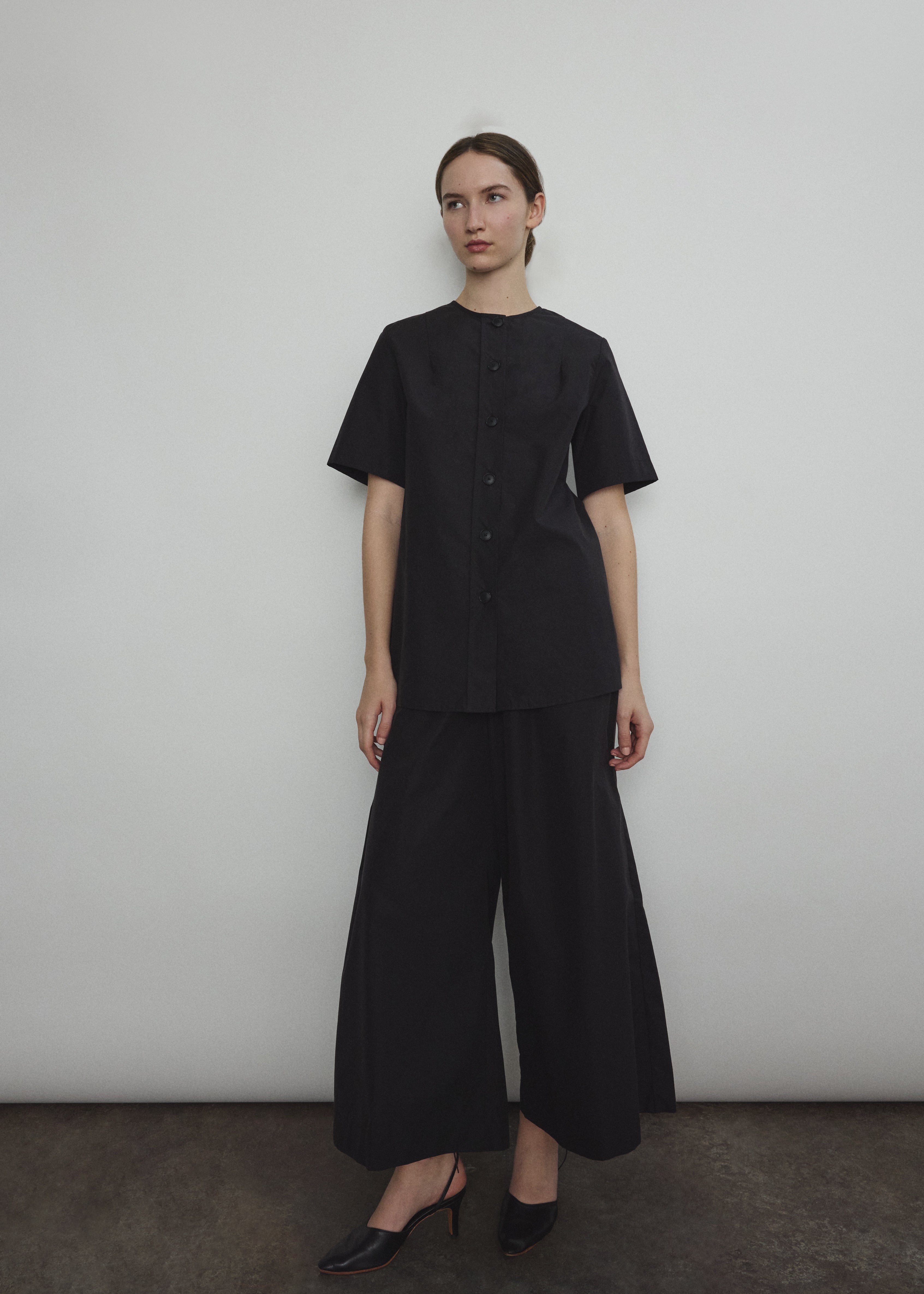 The black Kamperett Jette Cotton Tee styled with the Alix Pant for a modern minimalist look.