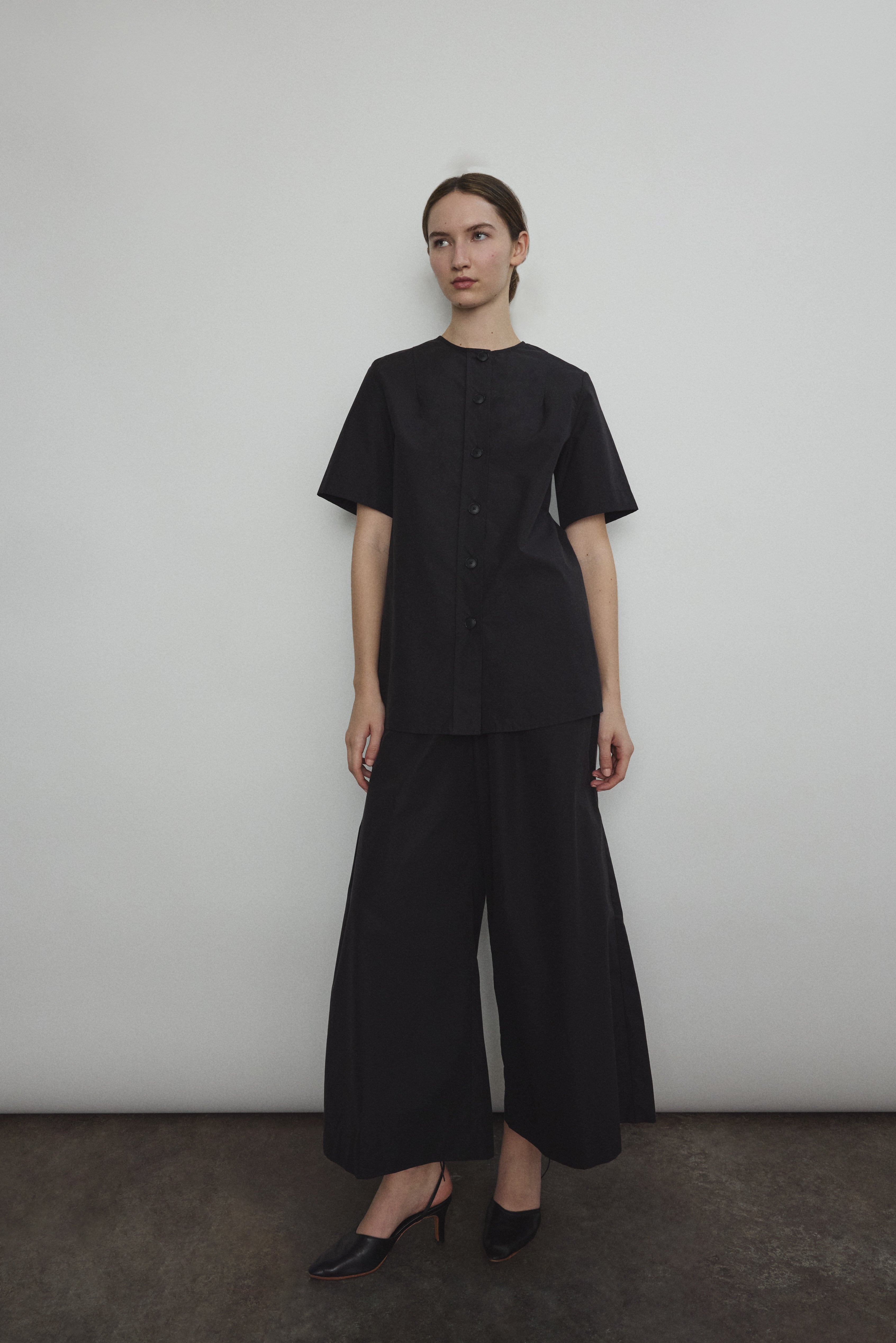 The black Kamperett Jette Cotton Tee styled with the Alix Pant for a modern minimalist look.