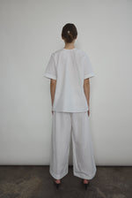 The white Kamperett Jette Cotton Tee styled with the Alix Pant for a modern minimalist look.