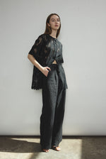 Angled view of the black French lace Kamperett Jette Tee with oversized reversible cut.