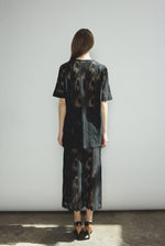 Back view of the black French lace Kamperett Jette Tee showing the reversible construction with shoulder darts.