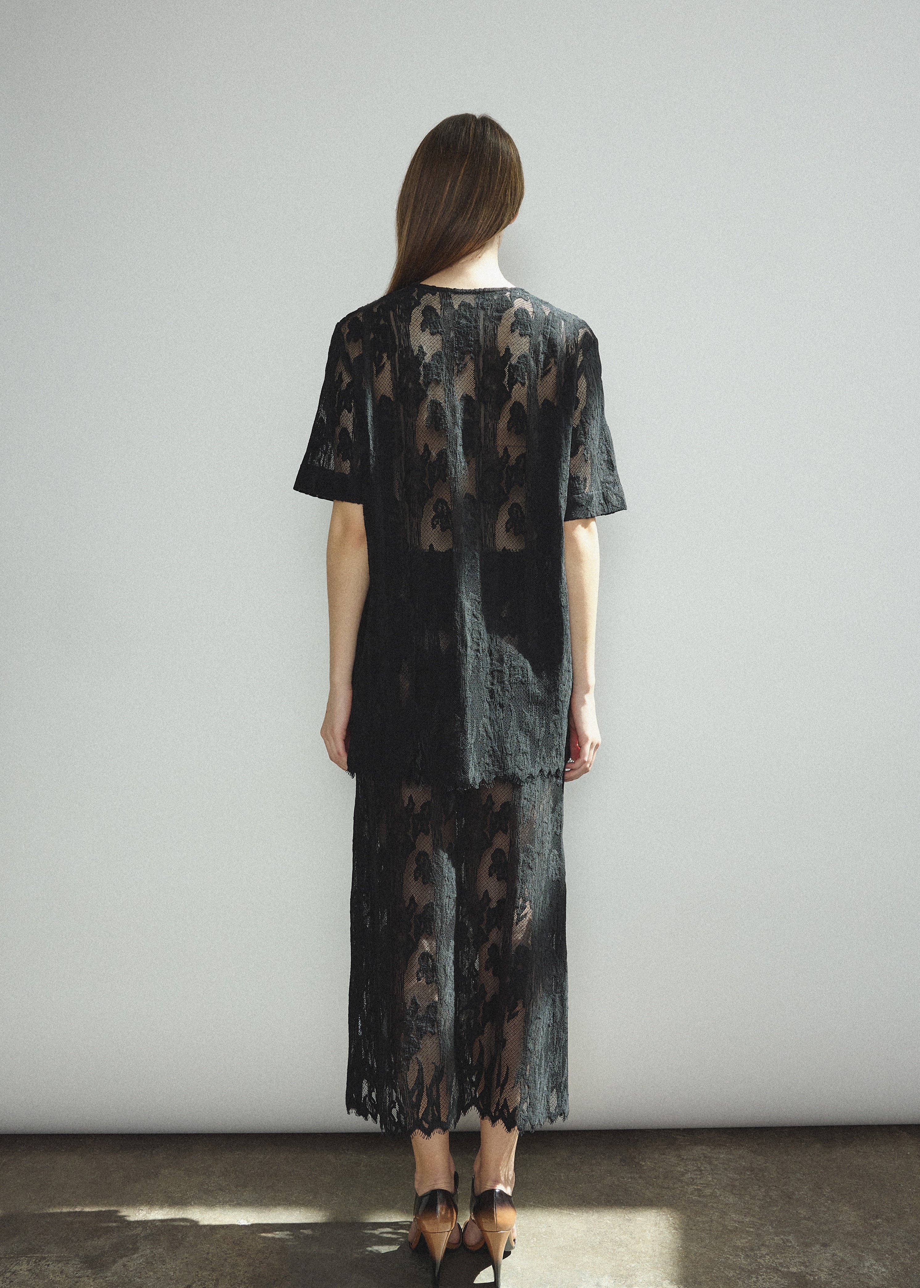 Back view of the black French lace Kamperett Jette Tee showing the reversible construction with shoulder darts.